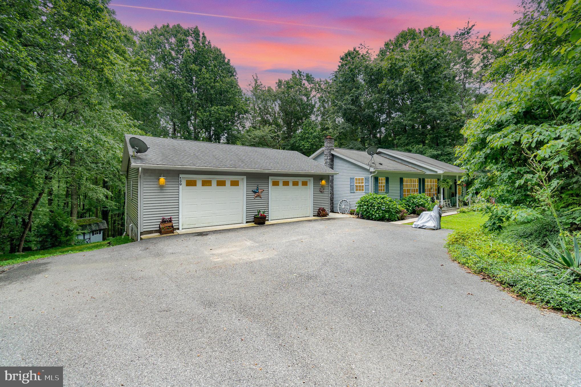 Welcome to peaceful country living at 150 Tapeworm Road, a well-maintained 4-bedroom, 2.5-bath ranch home situated on nearly 3 private acres in Perry County. This spacious home features a bright, functional kitchen with granite countertops, tile backsplash, and ceramic tile flooring. The living room offers hardwood floors and custom wood blinds, while the primary suite includes dual closets and a spacious bathroom with a tile shower featuring dual shower heads, river rock flooring, and a large soaking tub. Crown molding adds a refined touch throughout the home. The finished lower level offers flexible living space with hardwood flooring, a cozy wood/coal stove set against a mountain stone hearth, a bar/kitchen area, and a separate workshop or hobby space, perfect for entertaining, extended guests, or multigenerational living. Enjoy the outdoors from the large covered back deck, which overlooks a private, nature-filled backyard. A 2-car garage and two storage sheds complete the package, offering plenty of space for tools, toys, or outdoor gear. Tucked away in a quiet, scenic setting but still just a short drive to town, this home is a perfect blend of space, comfort, and privacy. Schedule your tour today and see what country living has to offer!