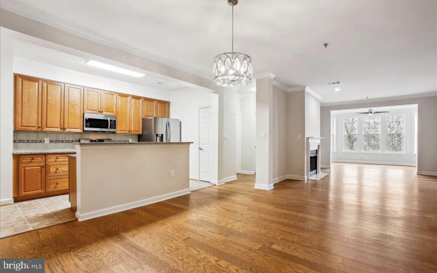 Experience luxury living in this beautifully updated 2-bedroom, 2-bath penthouse condo in the heart of Fairfax City! This spacious home features a sunroom with treetop views, an open floor plan with 9’ ceilings, crown molding, and a cozy gas fireplace. The gourmet kitchen boasts granite countertops, a large island, 42” cabinets, new stainless steel appliances, and gas cooking. The primary suite offers two closets (one walk-in), a tray ceiling, and a spa-like bath with a soaking tub and double vanity, while the second bedroom provides ideal space for guests or a home office. Enjoy hardwood flooring, fresh paint, in-unit laundry, two garage spaces, and a secure storage room. This smoke-free building offers a fitness center, meeting room, and on-site management. Ideally located steps from shopping, dining, and entertainment, with easy access to Rock the Block live music, historic sites, and more—schedule your tour today!