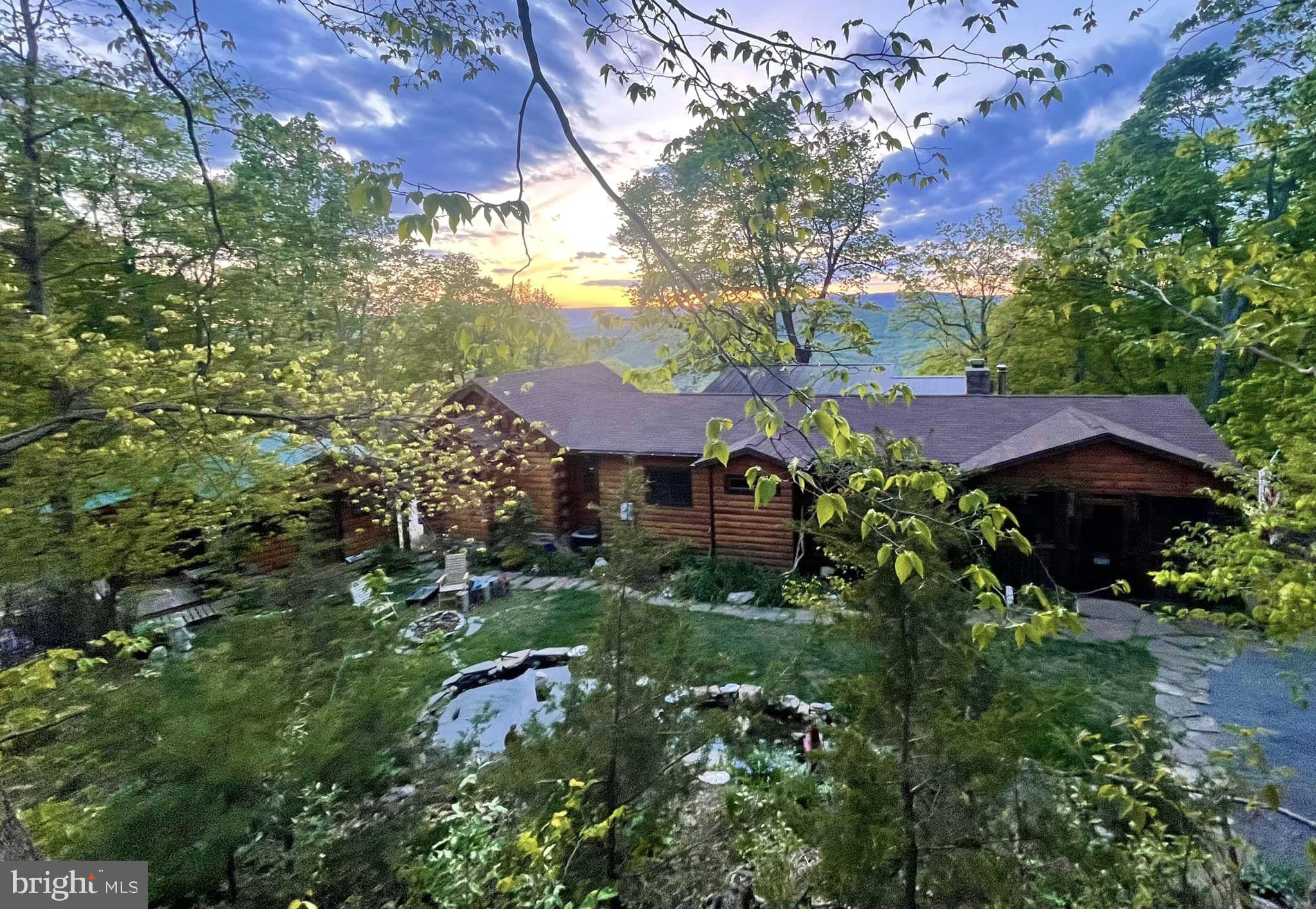Welcome to Lost River- West Virginia's hidden gem!
This stunning home offers natural beauty combined with modern comforts and serene living. This property is just under 6 acres and has breathtaking views of the surrounding mountains while creating a tranquil atmosphere that is truly captivating.
Step inside and be greeted by an abundance of warmth and charm. The open-concept layout creates a spacious and airy feel while large sliding glass doors let the sunlight bask the living areas with a natural glow.
The well-appointed kitchen features high-end appliances nestled in ample counter space and also a convenient breakfast bar. Culinary enthusiasts are going to love this kitchen that’s perfect for entertaining guests. The adjoining dining area offers a delightful space to gather for meals while enjoying picturesque views of the surrounding landscape.
Retreat to the comfortable bedrooms, each offering a peaceful oasis to rest and rejuvenate. The main suite is truly luxurious with its en-suite bathroom and access to a sunken hot tub. A perfect spot for savoring morning coffee while overlooking the scenic vistas.
The outdoor living space features an expansive deck with an extra-large screen room that is ideal for hosting outdoor gatherings or simply relaxing amidst nature's embrace. The front yard provides a tranquil sanctuary with stunning gardens and landscaping as well as a lovely pond, complete with tiny waterfalls and an abundance of fish, frogs and even a turtle.
An idyllic location paired with thoughtful design and natural beauty- this home presents a rare and exceptional opportunity. Don't miss your chance to make this extraordinary property your own and create cherished memories for years to come. Schedule your private showing today and prepare to fall in love with the allure of Lost River living.