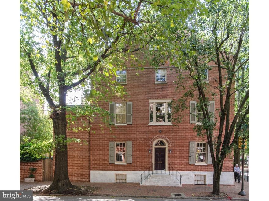 Extraordinary opportunity to own one of the most beautiful homes in Philadelphia - an amazing light filled home and an Architectural and Historic piece of Society Hill Philadelphia. Expansive center hall, four story, corner property with East, North and West exposures, a large, mature landscaped garden, a walkout basement with mechanical systems and good ceiling height. Wood floors throughout the house. This 4 bedroom, 2.5 bath home has a grand first floor with a gracious living room with wood burning fireplace, built-in bookshelves, beautiful dining room with wall of china storage and a wet bar. Cook's eat-in-kitchen with doors and windows to lush garden. Viking range, Miele dishwasher, large custom stone sink with drainboard, subway tile backsplash and large pantry closets, marble-topped island included for additional work space or eating. Second level has spacious corner library with marble fireplace and mantle and on the same floor as the master suite, with wonderful bright hall landing, bedroom with good closets and East-facing clerestory shuttered windows. Skylit master bath with large soaking tub, windows to garden, stall shower with bench, waterfall shower head, vintage look sinks, two mirrored medicine chests and large storage closets. The washer and dryer are on this level. Third level includes two spacious bedrooms each with windows on two sides and a family hall bath. The rooms have beautiful floors, high ceilings, and spacious closets. Fourth level has a dormer room overlooking the 3rd floor West bedroom and a spacious additional bedroom, study, home office or guest suite. Please take note of the beautifully curved stairway, the mature Wisteria vine on the garden trellis, the wood floors, the large utilitarian basement which walks out to the garden.  Many neighbors have a designated parking spot at the St. Peter's lot across the street. Prime Society Hill location close to shops, restaurants, historic sites, Ritz movie theaters, and Head House Square Farmer's Market. Sale includes pre-paid parking spot for one year in nearby lot.