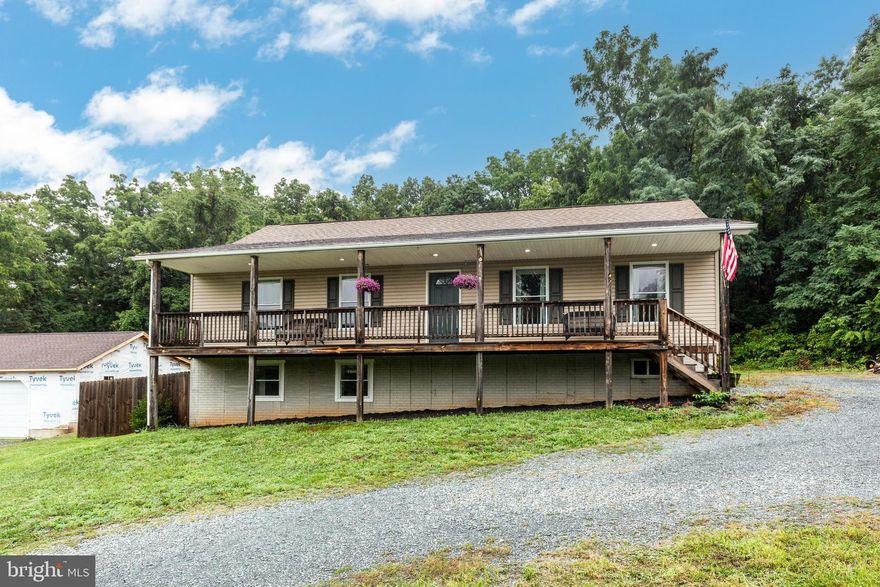 Welcome to your own little slice of perfection. Nestled on a stone road in the country, this 4 bedroom raised-ranch style home is already updated. Just move in and relax! Renovated in 2022 with all new laminate flooring, stainless appliances, and a new HVAC. **THIS HOME FEATURES NOT ONE, BUT TWO PRIMARY SUITES! **On the main level you'll find 3 bedrooms and 2 full baths along with a generous sized living room and kitchen/dining area. Downstairs in the light-filled lower level, another expansive primary suite awaits, along with a huge entertaining room with space for family, friends, games, toys, gym equipment, you name it! A private, fenced backyard with deck is ready for pets and friends, while the front porch waits for a quiet morning and the enjoyment of the mountain view and nature at it's finest. Recreation is right around the corner with skiing, tubing, hiking, golf, fishing, and more within a few miles of home. Close to the MD line and an easy commute from several directions. Come see what this home could have in store for you!