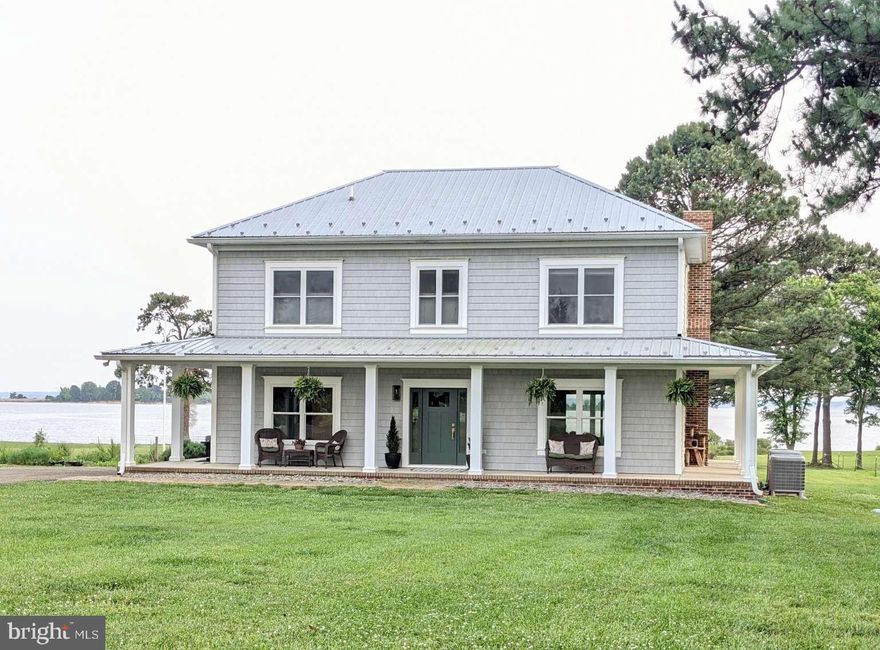 This private 7-acre waterfront estate will make you feel like you're on a permanent vacation. You'll have sweeping views of the Potomac River and across to the Stratford Cliffs in Montross, Virginia. Enjoy the sunrises and sunsets on your own private beach, while collecting seashells and seaglass. This custom home was constructed and professionally designed with an eye for the details. With a full wrap around porch and the waterfront side boasting a 40' long x 10' wide screened area, this location is perfect for eating crabs and entertaining. The custom cabinetry, built-in shelving, and custom closets throughout to promote maximum organization. A conditioned crawl space, gas fireplace, gas kitchen range, tankless water heater, deep drilled well and a high-efficiency two-zone heating, and air conditioning system are a few of the homeowner comforts. You don't have to look far to find upgraded features.
One of the three outbuildings was recently constructed and is 50' x 32' with a 14' lean-to, all with finished concrete floors. This building also offers a 1,600 sq. ft. unfinished upper level that is ready for your imagination. The second outbuilding is 48' x 16' with concrete floors and is primarily used to prepare new garden additions and to store related tools. The final outbuilding is a 31' x 21' animal shelter that is equipped with two stalls and a run-in. The property fields are cross-fenced and currently housing horses. The home is serviced by a conventional septic system and does not require flood insurance.