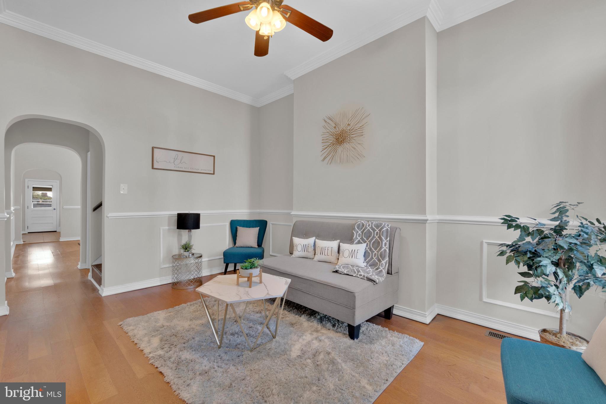 Upscale living in Highlandtown! This townhome is the perfect blend of modern finishes with the charm of old Baltimore. You are immediately greeted by the marble steps at the front entrance & formstone exterior. Open the front door to tall ceilings adorned with crown moldings, chair rail trim with timeless elegance. The laminate plank flooring leads you through arched doorways to a formal dining room & galley kitchen at the rear. The kitchen is finished with granite counters, ceramic tile flooring, & tile backsplash. The stainless appliances sparkle under natural light. At the rear is a covered rear deck overlooking your lawn, a rare amenity in Highlandtown. Imagine a vegetable garden with elegant flowers while you relax peacefully in your urban oasis. Back inside, the stairwell to the upper level is filled with light from the skylight displaying more trim to the 2nd floor. The bathroom has ceramic tile floors, & tile tub surround. Cylindrical lighting fills the bath with refined light. Tall ceilings remain in both bedrooms with more laminate plank flooring. The basement is improved with recessed lighting, a tiled flush, & convenient walk out to the rear yard, making storage a breeze. In the rear of the basement is additional storage space with a stall shower. Have peace of mind with a new roof in 2024.