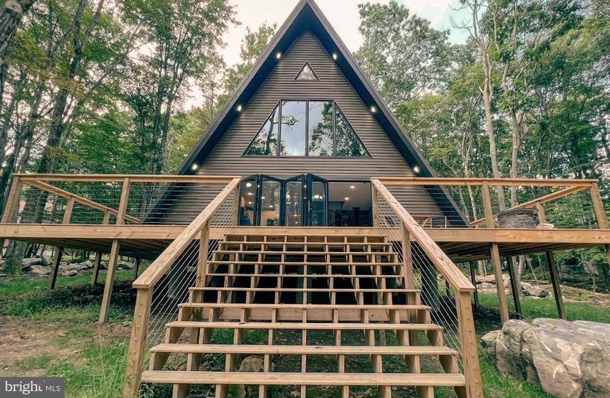 Coming Soon! This one of a kind modern A-frame is one you want to be sure not to miss! This income producing Airbnb is being sold turn-key and fully furnished. The current owners have lovingly maintained this nearly new property with no detail overlooked. Enjoy all four seasons from the main level living room featuring an open concept with tons of natural light, soaring ceilings, 12 foot accordion doors for breezy summer days, and a wood burning stove for snowy winter nights. Three Levels of living space and a large wooded lot with large mossy rock formations make the outdoor space feel like a private forest retreat. Located in beautiful Alpine Lake, a gated access resort where ownership offers a multitude of benefits including: an 18 hole golf course, mini golf course, Lake access, Hiking trails, biking trails. A great lodge overlooking the lake with an indoor swimming pool, fitness room, game room,  dining room, bar, and more! Whether you're looking for a second home or an investment property this property is sure to impress. Call Today for more information!