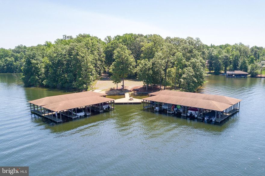 This quaint ranch style home is the ultimate getaway at Lake Anna. Built in 2014, this 3 bedroom/2 bath cul de sac home sits on almost 27 acres of land that includes 3 lots and only half mile away from your 3 covered docks and water access. Newly 2021 paved 5,100 sq. ft. driveway and a brand new 30 x 50 garage- boasting a 16 ft high ceiling and a 12 x 14 dual garage doors with side openers. This beautiful home has an open concept living area and wide plank maple floors that run through the living and all bedroom areas. Cook all of your favorite meals in your newly updated kitchen that features quartz countertops, a new sink, and a built in desk. Enjoy a nice cup of tea while getting a glimpse of some wildlife in the large screened-in porch that leads out to the 1 acre+ of the fenced-in backyard. The home comes equipped with ceiling fans in all rooms and soaking bathtubs in both of the bathrooms—store all your essentials in the multiple linen closets, pantry space, and a walk-in closet. Enjoy a number of outdoor activities on the two undeveloped neighboring lots (9-acres and 12-acres) that are located to the right of this property. The house also has a 90-yard target range right off the deck. The 9-acre lot that is adjacent to the house is a large, partially fenced in property that has a unique double-decker tree house with an observation deck allowing you to explore the nature and wildlife. The 12-acre lot has a beautiful stream running along its borders and contains a hunting cabin. Go on an adventure through a number of nature and ATV trails located through all three properties. Become an ultimate sportsman by utilizing the hunting cabin and the 3 covered electric-lift dock slips that come with the property and are located a short distance from the house. The future owner of the 3 lots can also reduce his/her annual tax liability to under $100 through the Forestry Program by keeping 20 or more acres of the land undeveloped. All in all, the three lots, totaling 26.8-acres, guarantee a private and relaxing getaway or an adventure-packed weekend for your family and friend.