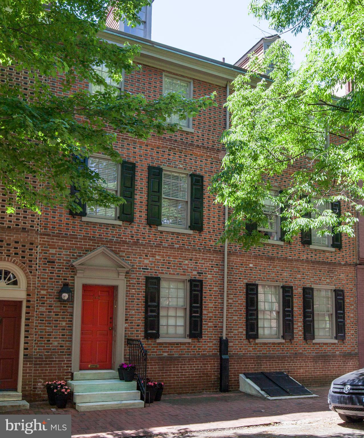 This 1792 double-width (32 ft) Society Hill Colonial Townhouse boasts one of the City's largest private gardens. Architect designed and occupied, the property seamlessly blends the best of all worlds: historically accurate exterior and 4-story plus full basement modernist interior. All floors enjoy views to the lushly planted bi-level garden. A true urban oasis, the home is generously sized as is or can expand within current zoning while still enjoying a large garden. The main entry provides immediate access to kitchen, coats at the front door, basement and powder room and leads to the full width generously proportioned, 20-foot high open plan Lower and Upper Living-Dining Rooms overlooking and opening to the garden and outdoor dining. A raised-hearth circular wood burning fireplace and a beautifully restored pre-1792 exposed brick wall are key features of this easy living entertainment space perfectly suited for intimate dinners or large gatherings. The eat-in chef's kitchen, which opens to both entry foyer and dining, features a commercial six burner, double oven gas stove and black walnut casework. Wine is stored in the naturally cool basement. A sculptural 6-foot diameter spiral stair connects to the private floors above. The 2nd floor dedicated Master Floor features a large Bedroom overlooking garden, full Bathroom, Dressing with an abundance of closets, Laundry and Library/Media Room. The 3rd floor has two large bedrooms, full bathroom, and a garden-side full-width studio with wood burning fireplace. Today used as office and gym, this studio easily adapts to other uses. The 4th floor is a finished carpeted full attic currently used as studio and storage. The full basement, accessible from the 1st floor hatch and 4th Street bulkhead, is very clean with well-maintained mechanical systems. Random-width dark stained pine floors throughout. East-West natural light abounds. Interior light wells and rooftop skylights bring additional light into the 3rd and 4th floors. This property reflects the varied history of Society Hill. Originally occupied by 18th and 19th century working class Philadelphians, converted to Hoffman Ironworks in the 20th century, acquired by the Redevelopment Authority in 1962, restored for residential use in 1968 and meticulously maintained up to present day, this property awaits its 21st century chapter. Residential on street permit parking. One year of pre-paid parking included in an off-street parking lot or garage within 2-3 blocks.