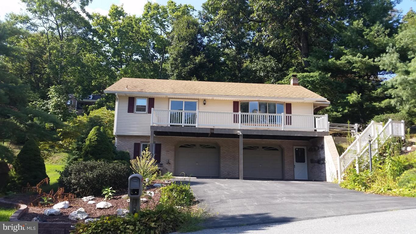 Fully redone home. LOTS OF GARAGE SPACE. New kitchen, carpet, bathroom and paint through out. Huge garage. Large bay window with lots of natural light. Very open flow. Has a lovely deck with beautiful views. Hempfield school district. Quiet and central location. Basement is to be painted. Verify sq footage.