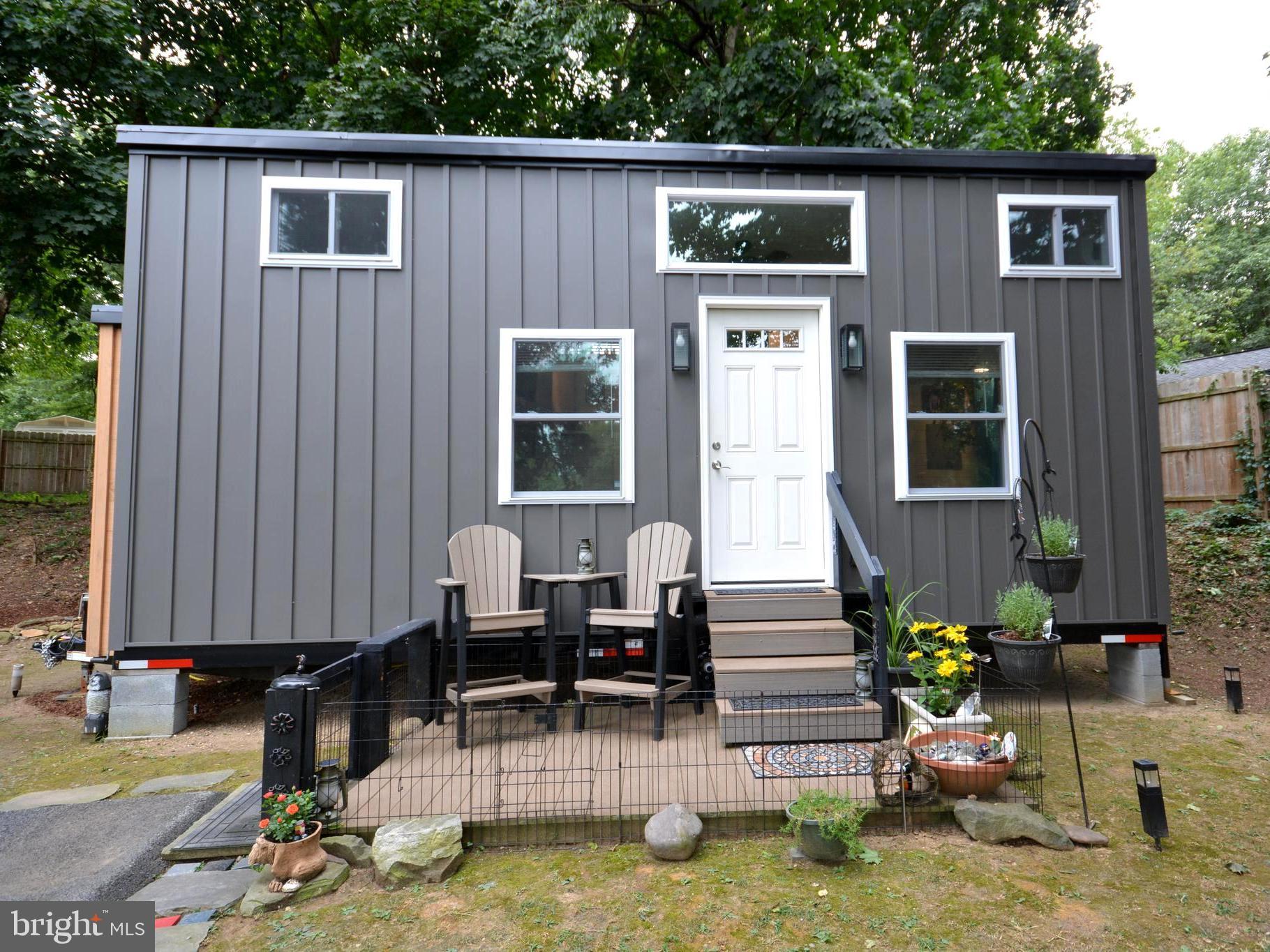 Looking for the perfect Tiny House retreat? This 2022 model by Liberation Tiny Homes offers modern comfort in a peaceful, gated community in Elizabethtown, PA. Tucked away at the rear of the grounds and surrounded by trees, it’s the ideal spot for privacy and seclusion. Inside, every detail has been thoughtfully customized—from the KT Highland kitchen with gas stove and refrigerator to the stunning walk-in shower you’ll love coming home to. Cozy living and dining space on the main level creates an inviting atmosphere, while the lofted bedroom above makes the most of the home’s efficient design. Pine siding brings warmth and character, and the outdoor deck is perfect for morning coffee or quiet evenings under the trees. With lot rent of just $725 per month—including water, sewer, electric, propane, internet, and trash—you’ll enjoy affordable, low-maintenance living in a truly unique setting.
