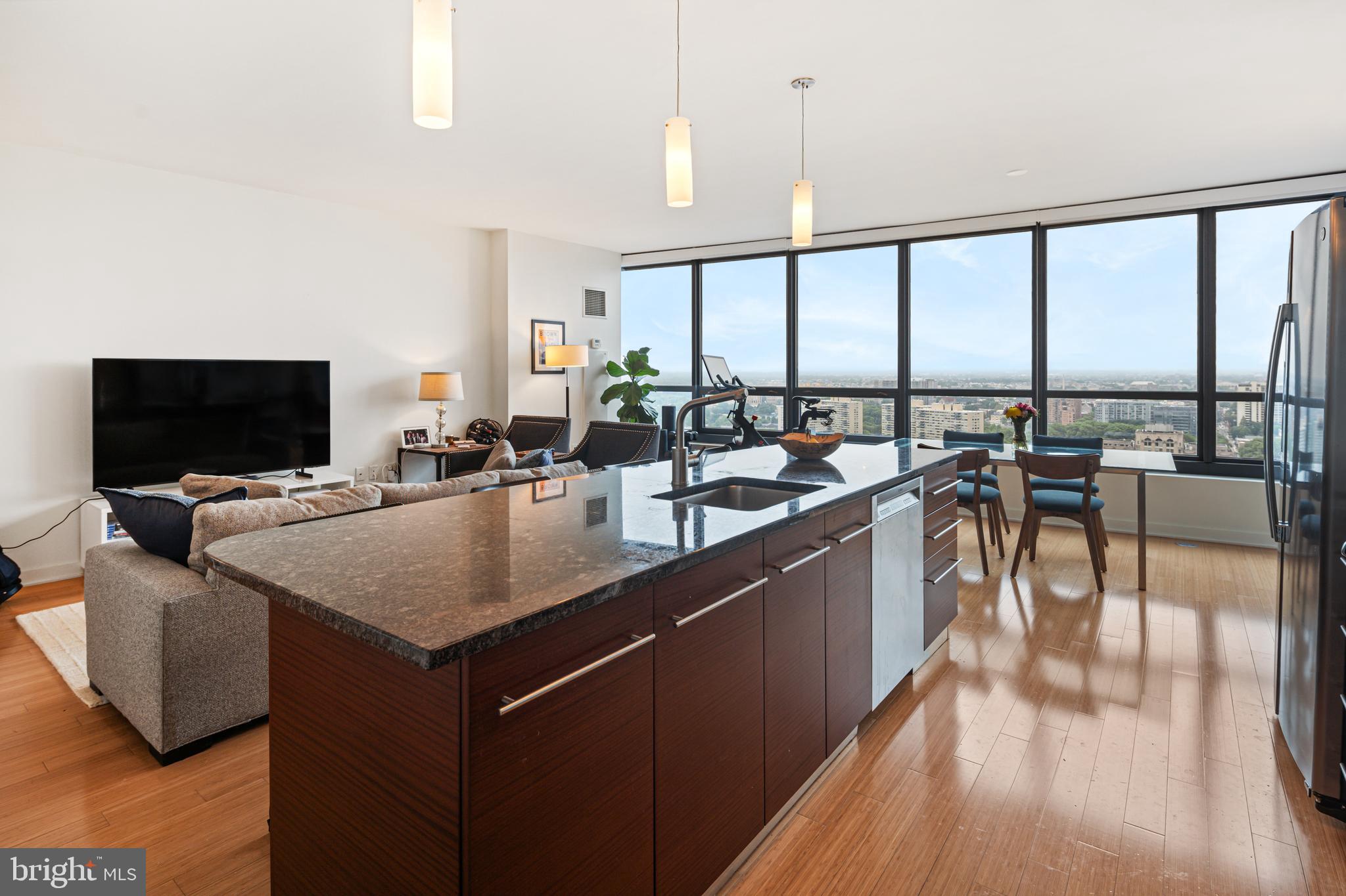 If you have been waiting for a coveted 01 unit at the Murano, now is your chance! Soaring 28 stories above the city, this exceptional 1 bedroom,1.5 bath 1,091 sq ft unit is the largest one bedroom floorplan in the building. This unit also has 1 car PARKING in a secure garage and a private storage locker included in the price.
As you enter the unit, prepare to be wowed. The floor to ceiling windows lining the living room make you feel like you are a bird flying above the city. Stunning northern views allow you to look down on the Art Museum and Boathouse Row and well beyond. You’ll be mesmerized. The beautiful kitchen features stainless steel appliances and granite countertops. The oversized bedroom has a large walk in closet and ensuite bathroom. The bathroom has a tiled shower, soaking tub and a dual vanity with lots of storage. A double coat closet lines the hallway as you enter the unit. There is also a half bathroom with a laundry closet. A private balcony where you can sit for hours staring at the city with a morning coffee or evening drink finishes off the unit. The entire unit features roller blinds for a touch of elegance. The Murano offers top-tier amenities, including a 60-foot lap pool, gym, sun deck, and 24-hour concierge/doorman. This building is pet friendly and is steps away from Trader Joe’s and all that Rittenhouse has to offer. It does not get easier than living here. Don’t miss your chance to own this rarely available unit!