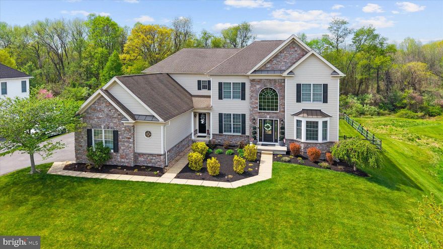Step inside to a dramatic two-story foyer, where a sweeping curved staircase with wrought iron spindles immediately draws your eye. The layout is both classic and functional, with the foyer elegantly dividing the living room, which features a bright bay window, and the formal dining room. A second staircase off the kitchen adds convenience and architectural interest.
The main living spaces are designed for both comfort and entertainment, highlighted by a spacious sunken family room measuring 21' x 20' with a gas fireplace. 9’ ceilings are on all 3 levels except the family room, which has a 10’ ceiling. The kitchen is equally impressive, centered around an oversized island with a downdraft cooktop, and enhanced by updated appliances, a generous pantry, and double windows that frame views of the private backyard. The adjoining breakfast nook opens directly to a large Trex deck, creating an easy flow for indoor-outdoor living. A tucked-away home office near the powder room provides a quiet workspace, while the first-floor laundry room offers cabinets and a utility sink. A well-equipped mudroom with additional storage adds everyday practicality. Storage is abundant throughout the home. The kitchen and upstairs bathrooms all have granite countertops. The powder room and basement countertops are marble. 
Upstairs, the owner’s suite is truly exceptional. Enter through double doors into a spacious 22’x16’ bedroom and a 16' x 13' sitting area and two expansive walk-in closets, one of which is a custom-designed 15' x 10' space with built-in storage. A secondary bedroom features its own private bath, offering comfort and convenience for guests or family members. The hall bath has a double vanity and access directly from each bedroom, not the hallway. 
The finished walk-out basement is a true highlight, offering an impressive 49' x 27' space filled with natural light from full windows and a double door that leads to the rear yard. Ideal for entertaining, it features a large wet bar built with cherry wood, a full bathroom, and a versatile room that can be used as a playroom or office.
Additional upgrades include both A/C units replaced with Trane units, the main heating system was also replaced with a Trane unit, a 50-gallon gas Bradford White water heater, and newer 6.5" plank engineered White Oak hardwood flooring by Hartco, known for its durability, waterproof design, and 50-year warranty. The exterior makes a lasting impression with its stone and Hardie board finish, thoughtfully upgraded from the original stucco, all windows replaced as well. Toll Brothers' documentation is attached to the disclosure. All work was completed by Toll Brothers contractors. 
Perfectly situated on a .47-acre lot with open space to the side and rear, creates a picturesque setting. This beautifully updated home offers a rare combination of privacy, space, and refined design. A welcoming double-front entry with a separate mudroom for everyday ease.
With a three-car side-entry garage, a fenced backyard, and a picture-perfect setting that offers both openness and privacy, this home is truly a standout—one that must be experienced in person to be fully appreciated.
This development has a clubhouse, gym, and pool!
