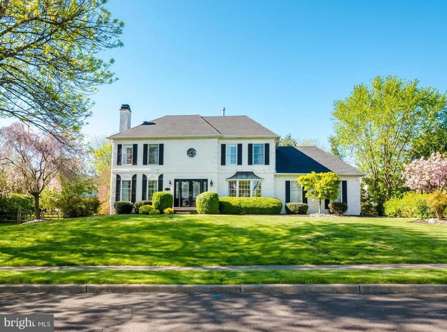 In highly desirable Yardley Crest, this stately colonial boasts four bedrooms, central music system, hardwood floors throughout, a finished lower level and lovely outdoor living.  As the spring brings fresh color to the landscaping, you enter through beautiful leaded glass doors to a two-story foyer with gorgeous hardwood floors and turned staircase. Framed with a craftsman mantle, the gas fireplace gives the formal living room a warm ambiance as directional accent lighting highlights your favorite artwork. In the family room a deep window seat, second gas fireplace and open appeal create a go-to gathering space for all the generations. A large casual dining area with wall of windows, vaulted ceiling and three skylights bring in the backyard views and lends access to the sunroom as the kitchen opens up give to the chef of the home a comfortable workspace featuring plenty of granite topped counters, the richness of raised panel cabinetry, tiled backsplashes, a walk-in pantry and stainless steel appliances. Ideal for an office, a well-appointed, versatile room also has wood flooring. The laundry room  gives you another backyard access, and a powder room is also nearby. The insulated three season room with raised ceiling  has beautiful green views from every window. The formal dining room with bay window, ceiling medallion and chair rail is ready to host the largest of dinettes. Double doors reveal the serene master suite featuring a huge custom closet, enough room to create a sitting area if you choose and a spacious master bath with his and hers vanities, a glass enclosed shower, soaking tub and the freshness of natural light from both a skylight and windows. Three additional bedrooms all have oversized double closets, lighted ceiling fans, streaming sunlight and share the common bath with double vanity and window adorned with plantation shutters. On the lower level you have great recreational space that is multi-functional, two additional bonus rooms currently used for storage that could potentially be a fifth bedroom, office, playroom or hobby space. Plus, you have a full bath making it perfect for extended family or out-of-town guests. You also have outdoor access on this level. The expansive patio invites you to enjoy your outdoor setting with tree-lined view and a sense of privacy. Make your showing appointment today!