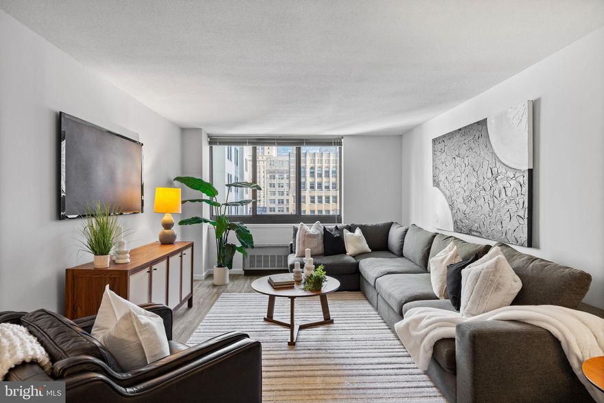 Fully updated one bedroom with tasteful upgrades and Center City views at Academy House. This expansive one bedroom boasts beautiful natural light from oversized windows, excellent closet space, and gray vinyl floors throughout. Enter through an open foyer with deep coat closet into the spacious great room offering a large living room showered in natural light and separate open dining area, ideal for entertaining. Adjacent to the dining space is a fully renovated kitchen with white shaker cabinetry, granite countertops, subway tile backsplash, stainless steel appliances, and a marble-like tile floor. The generously sized bedroom enjoys another oversized window, two wall closets, and use of the adjacent hall bathroom featuring a large white vanity with granite top, tub shower with modern subway tilework, upgraded tile floor, and laundry closet with stacked washer/dryer. Residents of Academy House enjoy a 24-hour doorman and a state-of-the-art fitness and aquatic center. There is valet parking in the building's garage for an additional monthly fee, subject to availability. The Academy House is located in the heart of Center City and within close walking distance to Rittenhouse Square, Washington Square, and the Broad Street and Market Street office corridors. The Philadelphia International Airport and Amtrak's 30th Street Station are easily accessible.