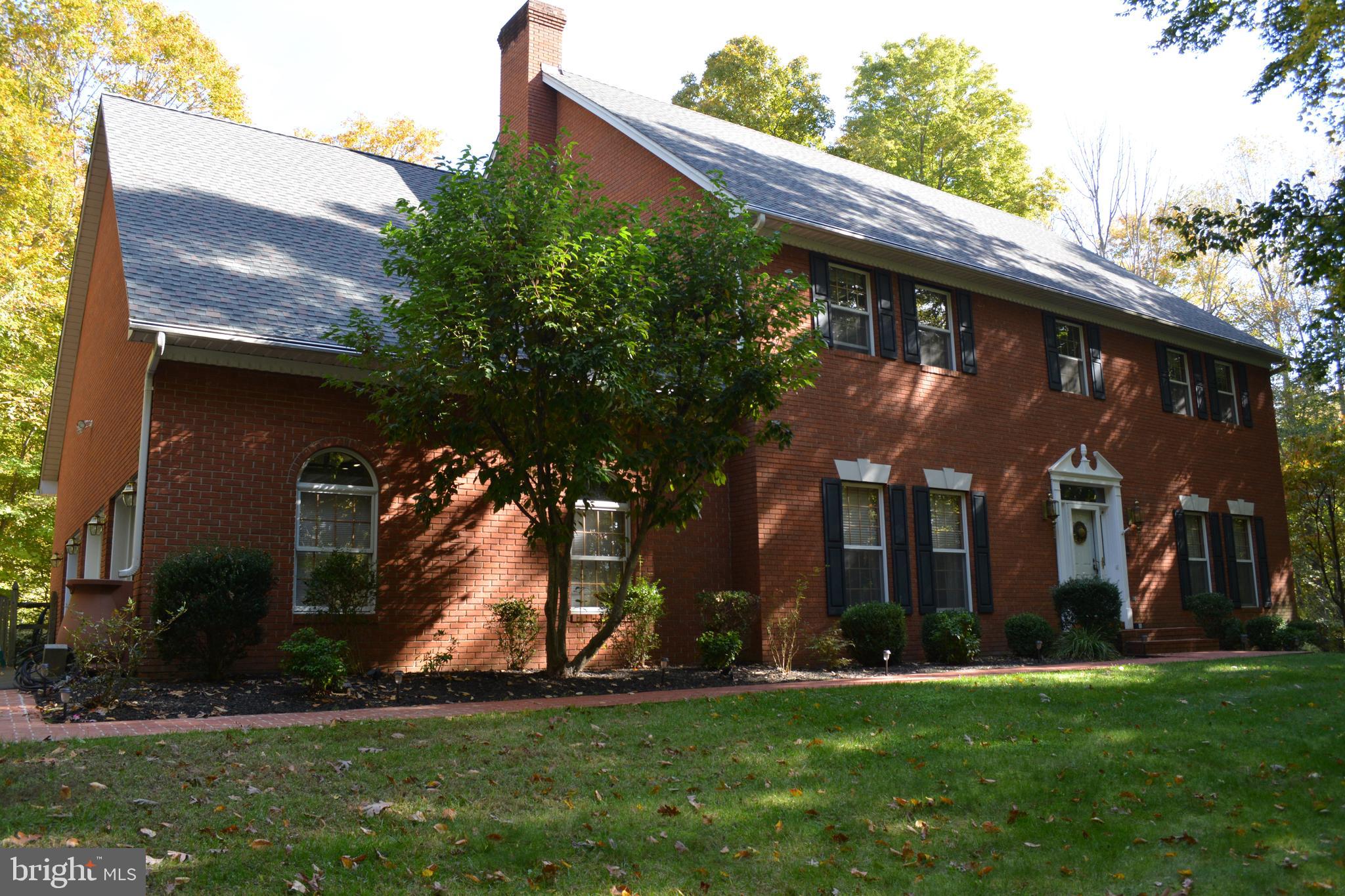 Secluded wooded setting offering the ultimate in privacy. You won't run out of space in the custom ALL Brick colonial! 1st Floor Mstr suite with all new master bath fit for the most selective owner. HUGE Family room w/ 2 story ceiling, brick FP, french door to the full length decking, front & back stair cases, oversized 3 car garage, plenty of paved parking, walk out basement, brick sidewalk, large lot, perfect set up for recreation of all types. Fresh Painting in lower level and some bedrooms, decking washed & stained. Shows well, move in ready! *NOT in town limits, NO town tax