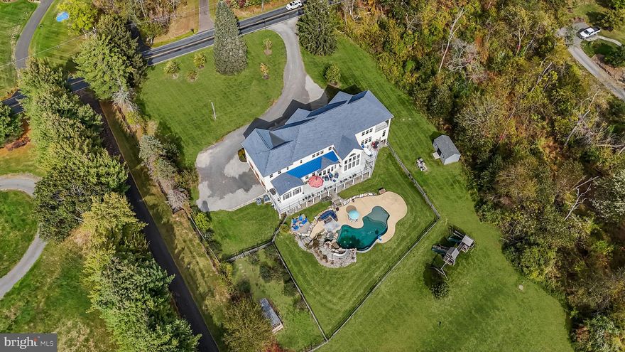 Custom Resort-Style Estate with Breathtaking Valley Views in Council Rock North School District Indulge in an unparalleled lifestyle within this custom-built, 5-bedroom, 5.5-bath single-family home, situated on a serene 4.94 -acre lot with panoramic valley views. Enter the grand, two-story stone foyer and be greeted by sheer elegance and exquisite design. This sophisticated estate seamlessly blends luxurious indoor living with a magnificent resort-style outdoor oasis, creating the ultimate retreat for discerning buyers. The heart of the home is the chef's kitchen, featuring top-of-the-line appliances, including a Sub-Zero refrigerator/freezer, an Italian ILVE eight-burner gas range, a Miele dishwasher, and a walk-in pantry. Beyond the kitchen, you will find: A private, first-floor home office , A bright sunroom overlooking the landscaped backyard. The second floor features four large bedrooms all with brand new carpeting, each with its own private bath and walk-in closets, plus a delightful secret bonus room currently set up as a playroom. Throughout the home, enjoy a built-in speaker and central vacuum system. This home features a convenient first and second-floor laundry rooms, with a dedicated dog shower on the main level. The newly finished basement elevates entertainment to new heights with a custom live-edge wet bar and kegerator, a temperature-controlled wine room, and a padded floor gym. Step directly from the basement into your outdoor paradise, which features a spectacular saltwater pool complete with a waterfall, waterslide, and enchanting grotto. The bluestone patio and covered deck with a built-in custom grill and second kegerator offer year-round entertainment possibilities. The property also includes a secure custom chicken coop. This extraordinary property provides the perfect combination of privacy, luxury, and entertainment for grand celebrations or quiet moments alike. All of this is located in the highly-acclaimed Council Rock North School district. This exceptional opportunity won't last long—schedule your private tour today. This home is withing a short drive to either Trenton or Doylestown Airports. NYC and Philadelphia are also with in a commutable distance. All 2nd floor carpets just replaced.