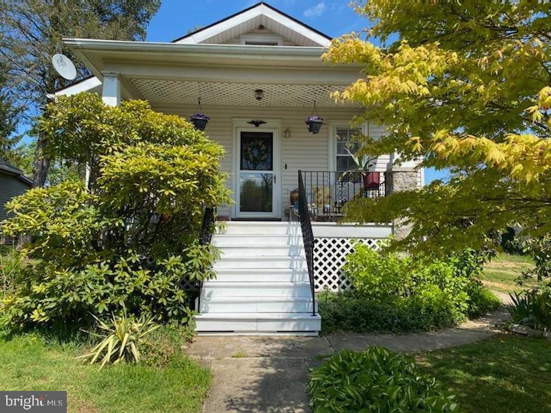 Welcome to 207 Elm Avenue, a charming, well-maintained and beautifully landscaped 4-bedroom and 2 bathroom Bungalow. This South-facing home with a flexible floor plan is drenched in sunlight all day. The covered front porch offers the perfect place to relax and enjoy the abundance of plantings that adorn the property. From the front porch, enter the living room that connects to a second living area, that co formal dining room, featuring a sun-filled bay window and original built-in comer cabinet. The first two bedrooms are accessed from this room and a small hall leads to the main bathroom. Moving through the house is a dining area off the kitchen with a delightful pass-through from the kitchen and ample cupboard space. The farmhouse kitchen with stainless steel appliances boasts a cathedral ceiling that fills with morning sun: perfect for that first cup of coffee! Off the kitchen is the 3rd nicely sized bedroom with access to the main bathroom and the walk-up attic with additional storage space. From the dining area are the steps to the fully finished basement with a sitting area, generous closet space, a second full bathroom, laundry room with newer washing machine and the 4th bedroom. The utility room has a newly installed access door that leads to the side of the house. From the kitchen you have access to the fully-fenced backyard with a fabulous patio for outdoor entertaining. Just when you thought it couldn't get better, fulfill your dreams of poultry farming with the Amish-built chicken coop and custom fox and hawk-proof 13x20 ft chicken run. The property is on a double lot with two separate tax ID numbers, 2nd is # 27-00-00538-00, it measures (50 x 150) . The combined lot is.34 acres, just the right size to have your own manageable vegetable garden. Detached from the home is a garage with a built-in workspace, room for lawn equipment and a spacious storage loft. Adjoining the garage is a recreation room currently used for ping-pong and exercise equipment with an additional storage loft accessed by pull-down stairs. Newly refinished and stained pine floors through-out. Located in the award I district in a family-friendly neighborhood close to the Chester Creek Trail. Convenient to Rt 1 and Rt 452, 207 Elm Avenue is amazing value with low taxes. Move quickly on this rare opportunity!