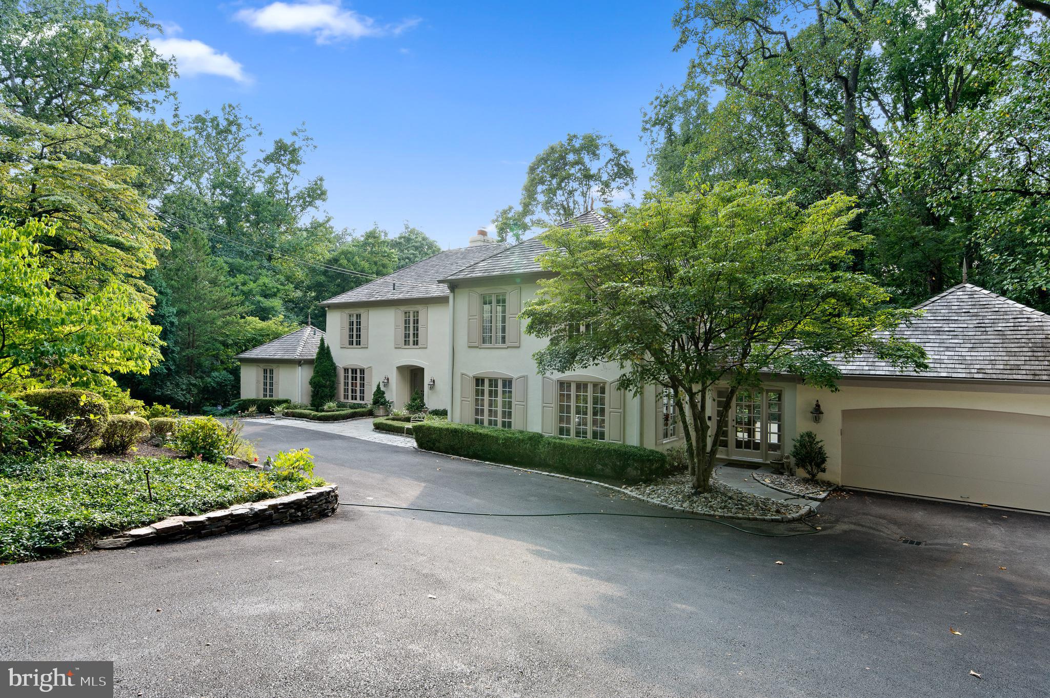 Elegance and sophistication define every corner of this French Colonial home, peacefully tucked away on a beautiful tree-lined street near downtown Gladwyne. Past an impeccably landscaped courtyard, discover a sunlit foyer displaying an impressive fusion of gorgeous millwork, volume ceilings, and rich hardwood flooring. Graceful archways usher you to the main gathering areas, from the chandelier-lit dining room adorned with classic wainscoting to the step-down living room warmed by a double-sided fireplace. Seamlessly transition into the kitchen equipped with everything you need, including a picturesque breakfast nook. Soft sunlight and ceiling fans create a comfortable atmosphere in your private retreats, two of which are accommodated by a tastefully tiled hall bath. Dual walk-in closets and a luxe 5-piece ensuite with an oversized steam shower adjoin the primary suite. Multiple entertaining areas are ready for your weekend parties, from the awning-covered balcony and lower-level den to the backyard pool and spa. Other noteworthy offers are a laundry room, a versatile office, and an attached 2-car garage. Let your real estate dreams come true by taking a tour today!
