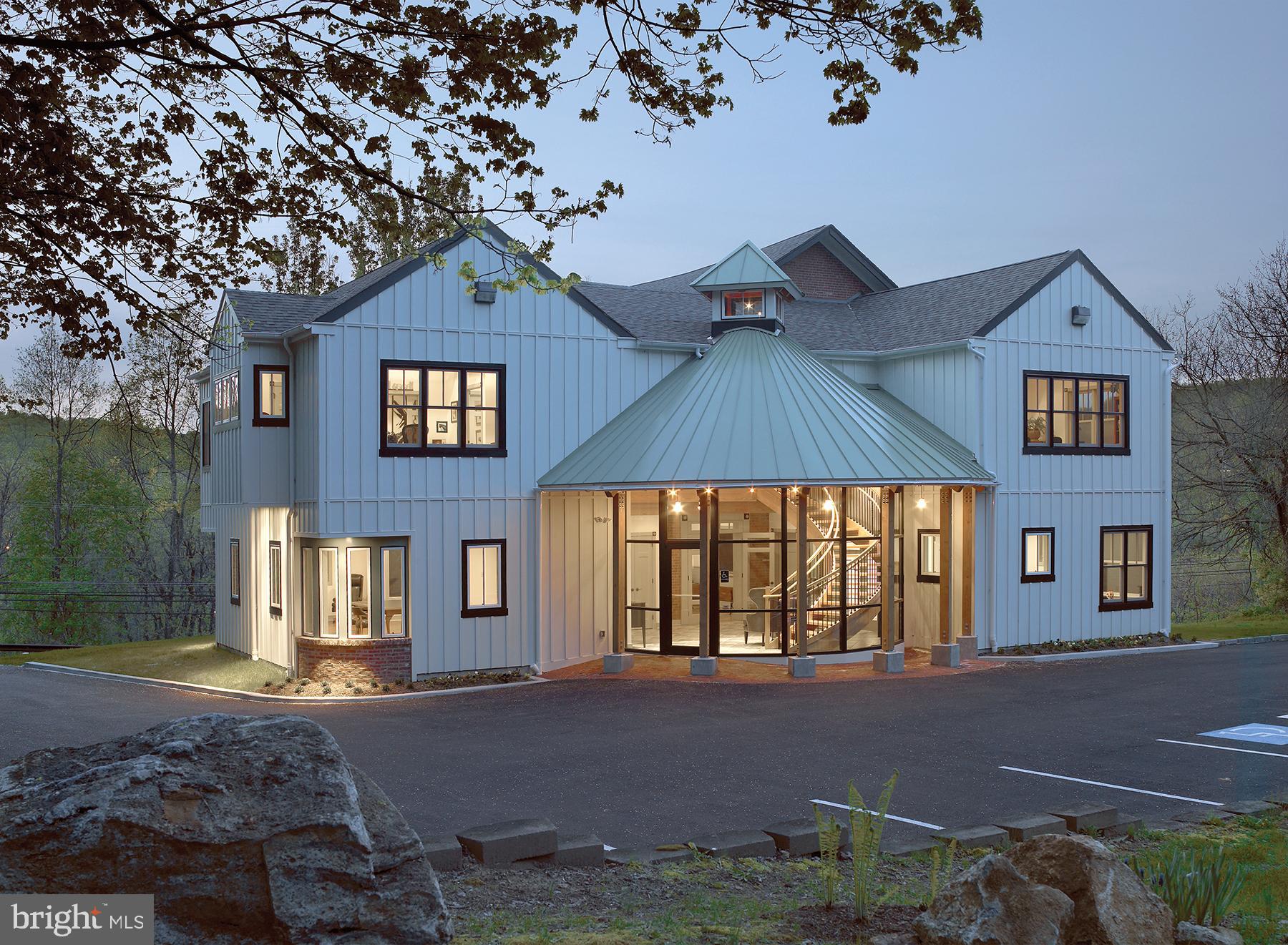 Introducing luxury office space, redefined and reimagined! Situated on 1.3 acres amid Chester County’s rolling hills overlooking Kimberton Road (Rt. 113) and the thousands of cars that pass daily below , this unique commercial office building is sure to impress the most discerning business professionals and clients! Originally constructed in 1907 to house the West Pikeland High School before serving as the West Pikeland Municipal Building for more than 50 years, this property was last purchased in 2007, then renovated and lovingly restored in 2009 by the current owner. It’s now brimming with the historic charm, character and period details of a century-old Schoolhouse, complimented by a modern addition that marries seamlessly with the existing structure. Upon arrival, guests are welcomed into a dramatic 2-story lobby accented by tile flooring, a timber-beam ceiling, curved floor-to-ceiling window wall, original exposed brick details and a sweeping, oak staircase. Surrounding the lobby is approximately 6,400 SF of beautifully-appointed, luxury office space that can be divided into separate suites and leased or combined for use in it’s entirety by a single business or firm. The first floor features two spacious corner offices, one ADA-accessible half bath and one full bath with shower, a Pullman-style Kitchenette equipped with custom cabinetry, sink, full-size refrigerator and exposed brick wall, and a large work or gallery space that originally served as the main room of the Schoolhouse. This large room is accented by original hardwood flooring, 10’+ ceilings, distinctive custom moldings, deep window sills and a stained-glass transom above double doors leading to the front Foyer and stairwell. Upstairs features a balcony overlooking the Lobby below, a large corner conference room and two private office suites with exposed beams, two half baths and an additional Kitchenette with custom cabinetry, sink and mini-fridge. A spacious and light-filled 800+ SF studio space (currently home to a successful advertising firm) completes the second floor. The partially-finished walk-out basement and a crawl space below the addition provides abundant storage and houses the building’s mechanical systems, including separately zoned HVAC. A private parking lot at the rear of the building includes 26 dedicated parking spaces for employees and guests with convenient access to the building’s main Lobby entrance. The building sits adjacent to the Chester Springs Post Office and shares ingress and egress, increasing its visibility to the many patrons who visit the post office each day. Zoned V-2 (Village Preservation District), permitted uses for this property include professional or administrative offices, home occupation, bed & breakfast, retail and even the possibility of Residential use (please see West Pikeland Zoning Ordinances, pages #VI-4 through VI-6 for permitted uses.) Located within an hour’s drive of the Philadelphia International Airport, this property’s convenient location provides easy access to Rts. 113, 401, 202, 30, and the Pennsylvania Turnpike. The extensive restoration and renovation efforts were meticulously executed with no expense spared or detail overlooked. This is truly a unique and exceptional professional building that inspires creativity for those lucky enough to work within these walls and leaves a lasting impression on the guests and clients who visit. This special piece of Chester Springs’ history is now ready for a new steward to envision the next exciting chapter in it’s storied past! (Also listed as Residential under MLS #PACT2002650)