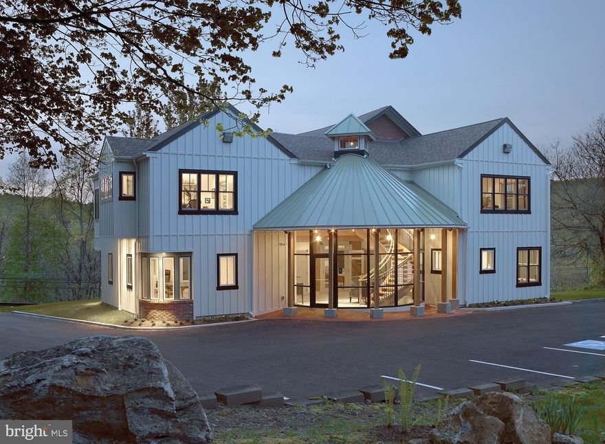 Introducing luxury office space, redefined and reimagined! Situated on 1.3 acres amid Chester County’s rolling hills overlooking Kimberton Road (Rt. 113) and the thousands of cars that pass daily below , this unique commercial office building is sure to impress the most discerning business professionals and clients! Originally constructed in 1907 to house the West Pikeland High School before serving as the West Pikeland Municipal Building for more than 50 years, this property was last purchased in 2007, then renovated and lovingly restored in 2009 by the current owner. It’s now brimming with the historic charm, character and period details of a century-old Schoolhouse, complimented by a modern addition that marries seamlessly with the existing structure. Upon arrival, guests are welcomed into a dramatic 2-story lobby accented by tile flooring, a timber-beam ceiling, curved floor-to-ceiling window wall, original exposed brick details and a sweeping, oak staircase. Surrounding the lobby is approximately 6,400 SF of beautifully-appointed, luxury office space that can be divided into separate suites and leased or combined for use in it’s entirety by a single business or firm. The first floor features two spacious corner offices, one ADA-accessible half bath and one full bath with shower, a Pullman-style Kitchenette equipped with custom cabinetry, sink, full-size refrigerator and exposed brick wall, and a large work or gallery space that originally served as the main room of the Schoolhouse. This large room is accented by original hardwood flooring, 10’+ ceilings, distinctive custom moldings, deep window sills and a stained-glass transom above double doors leading to the front Foyer and stairwell. Upstairs features a balcony overlooking the Lobby below, a large corner conference room and two private office suites with exposed beams, two half baths and an additional Kitchenette with custom cabinetry, sink and mini-fridge. A spacious and light-filled 800+ SF studio space (currently home to a successful advertising firm) completes the second floor. The partially-finished walk-out basement and a crawl space below the addition provides abundant storage and houses the building’s mechanical systems, including separately zoned HVAC.  A private parking lot at the rear of the building includes 26 dedicated parking spaces for employees and guests with convenient access to the building’s main Lobby entrance. The building sits adjacent to the Chester Springs Post Office and shares ingress and egress, increasing its visibility to the many patrons who visit the post office each day. Zoned V-2 (Village Preservation District), permitted uses for this property include professional or administrative offices, home occupation, bed & breakfast, retail and even the possibility of Residential use (please see West Pikeland Zoning Ordinances, pages #VI-4 through VI-6 for permitted uses.)  Located within an hour’s drive of the Philadelphia International Airport, this property’s convenient location provides easy access to Rts. 113, 401, 202, 30, and the Pennsylvania Turnpike. The extensive restoration and renovation efforts were meticulously executed with no expense spared or detail overlooked. This is truly a unique and exceptional professional building that inspires creativity for those lucky enough to work within these walls and leaves a lasting impression on the guests and clients who visit. This special piece of Chester Springs’ history is now ready for a new steward to envision the next exciting chapter in it’s storied past! (Also listed as Residential under MLS #PACT2002650)