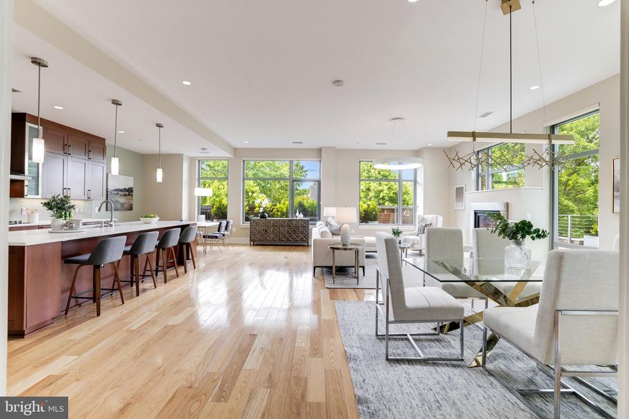 Sophisticated and luxurious, this 3 bedroom plus office and 2.5 bath residence is surrounded by mature trees, and special  plants in an L shaped extra large patio.   In this end unit, natural light fills the interior space all day long.  Ceilings throughout are a wonderful 10'9" high.  The open concept floor plan with floor to ceiling windows is dramatic and enhanced by an indoor/outdoor two-sided gas fireplace opening to the patio.   The great room is spacious for entertaining and accommodates a large dining table for enjoying a wonderful meal.  A chef's kitchen offers  top of the line Wolf cooktop, microwave and Subzero refrigeration.  Custom built-ins in the office are carefully designed with a library-type ladder.  The guest rooms and full bath are well appointed and feature additional floor to ceiling windows.  The primary suite offers two custom walk-in closets, a spa-like bath with large marble shower, and a linen closet.  Two parking spaces convey with the property along with a storage room.  Amenities of The Oronoco include 24-hour security and  staffed lobby, heated outdoor pool, fitness and yoga rooms,  meeting room, children's play room, a dog-washing station plus a bicycle storage room.   Enjoy the waterfront park, nearby shopping, great restaurants, the walk-jog-bike trail and close proximity to King Street and all Old Town has to offer.