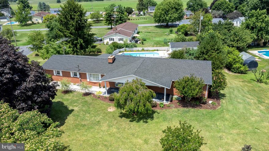 Welcome to this delightful all-brick rancher nestled on a generous .48-acre corner lot, located minutes from either Inwood or Martinsburg, WV.,   just a short distance away from everyday amenities.  With 3 bedrooms, 2 baths, and 1,878 square feet of living space, this home provides a comfortable and spacious layout for you and your loved ones to enjoy.
As you step inside, you'll appreciate the solid construction and timeless appeal of the all-brick exterior, ensuring durability and low maintenance for years to come. The newer roof adds peace of mind, protecting your investment and offering worry-free living.
While this home could use some TLC in the form of paint and carpet, it presents an excellent opportunity to customize and transform it according to your personal style and preferences. Let your imagination soar as you envision the potential to create a truly personalized haven.
 The beautiful, inground pool offers a refreshing oasis during warm summer months—a perfect spot for relaxation and entertaining friends and family.
Don't miss this opportunity to own a charming all-brick rancher on a large corner lot with an inviting pool. Embrace the chance to add your personal touch and create the home of your dreams. Schedule a showing today and seize this remarkable opportunity!