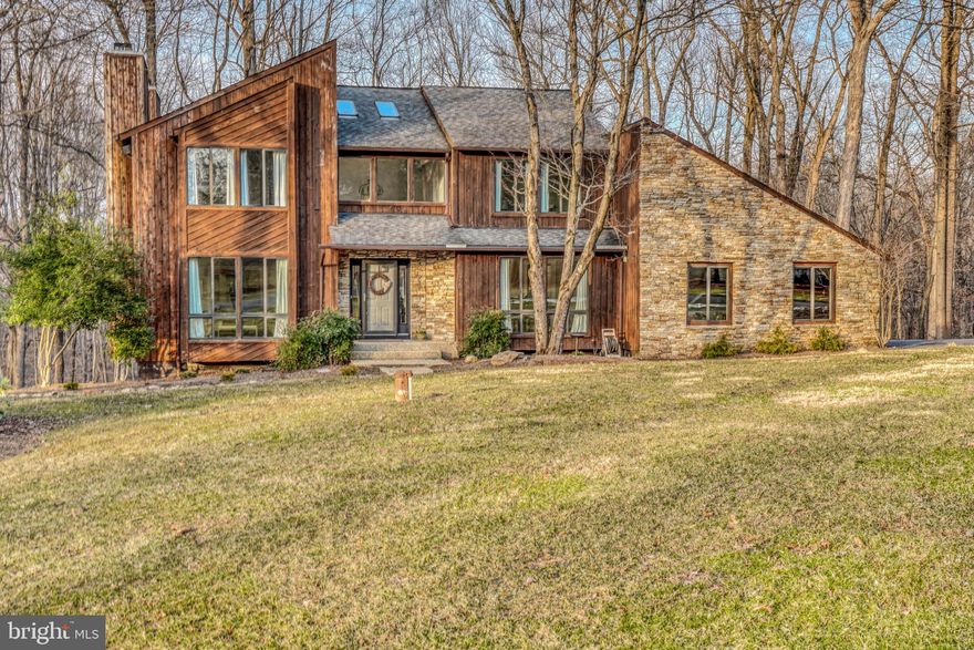 Have you been searching for a house with tons of characters, a large lot that has a private, secluded feel but is only 10 minutes to 83 and 695? Well then this home is for you! This contemporary home is all about natural light and open, usable spaces. There are no fussy unused rooms in this house.  You'll love the terrific living room with it's tons of floor to ceiling windows and working fireplace. You have a separate dining room which is perfect for many holiday gatherings or dinner parties. The kitchen is lovely with chic gray cabinets, tons of storage and a center island. There is also more informal dining space off the kitchen as well--just perfect for a quick breakfast or a cozy dinner.  Beyond the kitchen is a sweet family room with a stacked stone fireplace. The upstairs has three huge bedrooms, each with abundant storage space and tons of windows. The owner's suite has it's own sitting room, entry to a rear balcony and an en suite bathroom that has to be seen to believed. It's a true luxury spa experience. The basement is fully finished with a 4th bedroom, full bathroom, rear family room and several storage rooms. Finally don't miss the rear deck and it's enclosed screen porch--both are perfect to watching the plentiful wildlife that roams this gorgeous 3.3 acre lot that even has a stream that runs through it.  Owners have made many improvements, some of which are  new inside and outside HVAC unit 2020,  new water heaters (there are two) one was replaced in 2019 and one was replaced in 2020,  new well pump 2019, and that's just for starters.  AGENTS: PLEASE PARK IN THE CUL-DE-SAC AND WALK TO THE HOUSE TO SHOW. WE DON'T WANT THE NEIGHBORS BLOCKED IN ON THE SHARED DRIVEWAY BY ALL THE APPOINTMENTS.