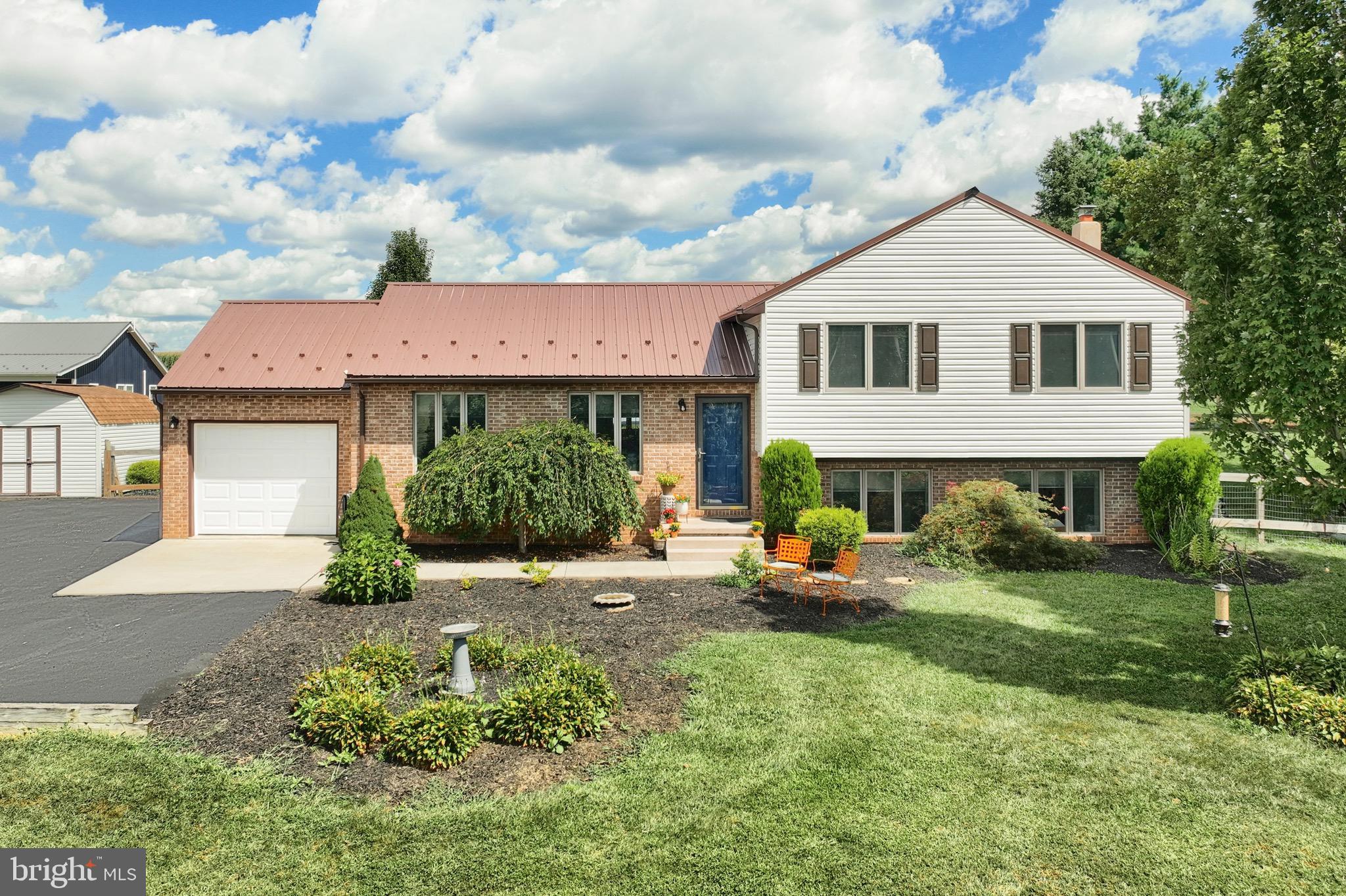 With acres of rolling countryside and farmland all around, this beautifully renovated split-level home rests on a delightfully private 1.13-acre lot . All 4 levels of this home have been finished to maximize living and storage space. Hardwood floors on the main and upper floors, heated tile floors in both full bathrooms, a large family room with a half-bath, porcelain tile, a high-efficiency wood stove installed and personalized amenities are the highlights of this open floor plan. In the Kitchen you will find Granite, stainless steel appliances and backsplash, a large pantry, access to a large back patio, a breakfast bar. The Family Room's walk-out opens onto the back patio. Additional features include an amazing laundry room with workspace and a specially designed clothes organization system, a floating vanity and laundry chute in the hall bathroom, and primary suite.A Private office on the lower level is sure to make a comfortable space to work from home.New Hot water heater in 2024 ,HVAC and mini split. The many selling points include all new siding and roofing in 2025, garage with storage organizer and a new garage door installed in 2025. Despite being tucked away, it is still minutes from Red Lion, Shrewsbury, and the PA/MD Line. The list is endless; to fully enjoy everything this property has to offer, you must visit!