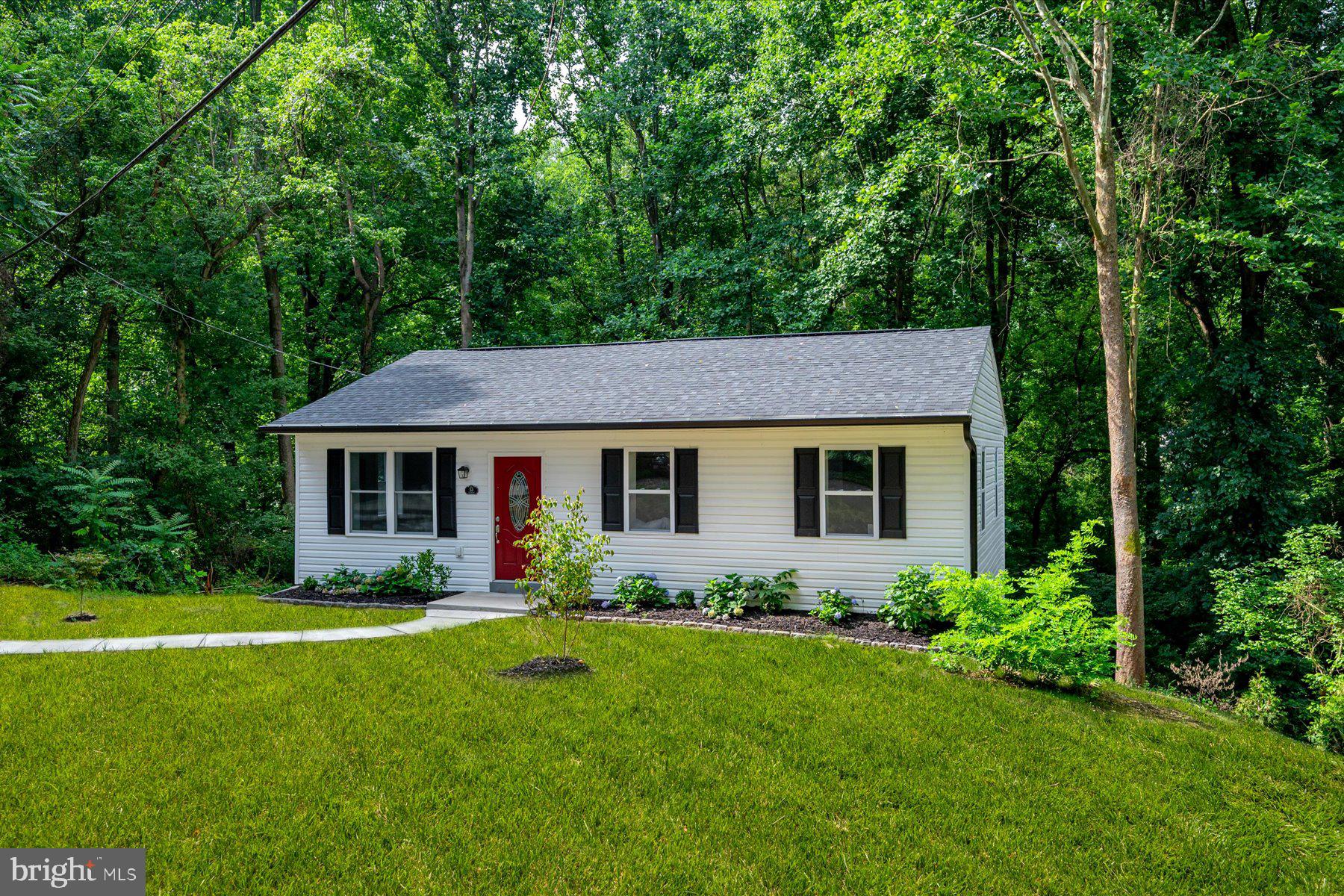 Renovated in 2025, this home offers four potential bedrooms across two levels and sits on a full acre backing to trees. Interior upgrades include a new kitchen, updated bathrooms, and HVAC system, while exterior improvements feature a new roof and siding. The main level includes a kitchen, dining area, living room, two bedrooms, and a full bath. The walkout lower level features two additional rooms with bedroom potential, a half bath, family room, laundry area, utility space, and storage under the stairs. New permitted septic tank 2025.
Tucked into a peaceful setting, the property remains well-connected via Routes 4 and 301 balancing privacy with accessibility to local parks, shops, dining, and commuter routes into the D.C. metro area.