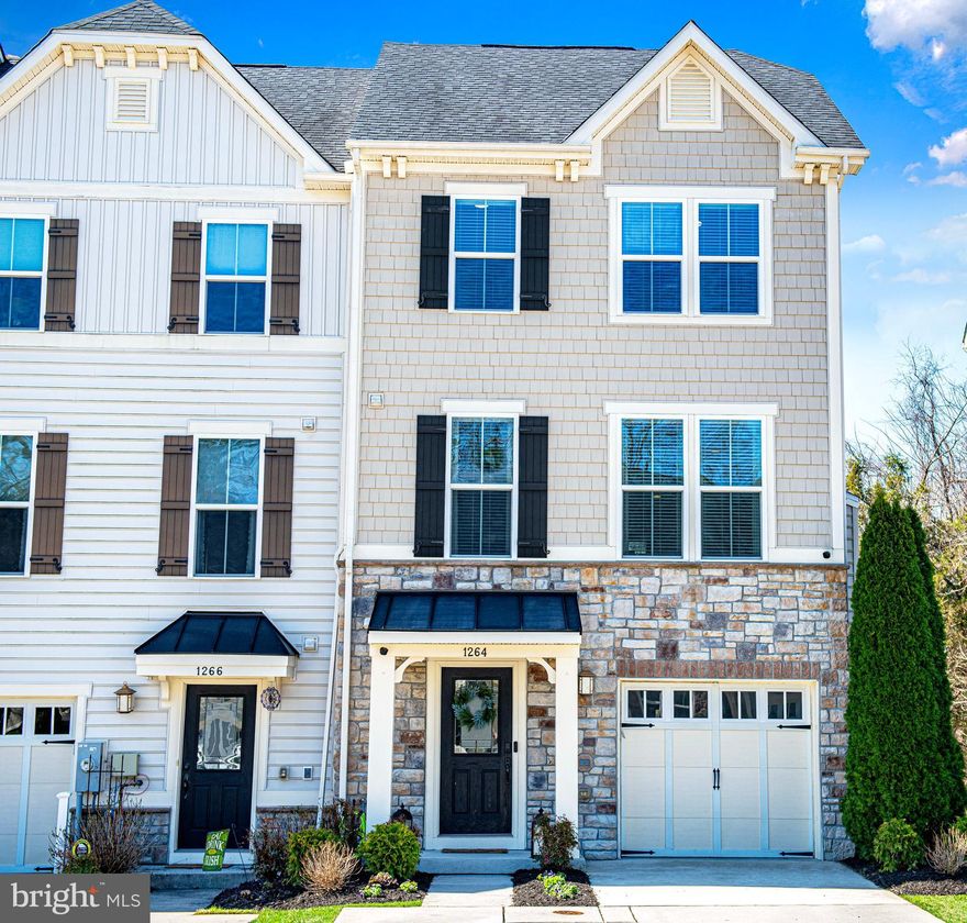 Welcome to this beautifully maintained end-of-group townhome in the sought-after Magness Mill community, built in 2015 and offering three finished levels of modern living. The entry level features a welcoming foyer with durable flooring, a convenient powder room, and a versatile lower-level layout—half configured as a spacious game room with direct access to the backyard, and the other providing additional functional living space. Step outside to enjoy the patio and landscaped, fully fenced backyard. Upstairs, the main level showcases a bright, open-concept design with rich flooring throughout. The stylish kitchen is the heart of the home, complete with granite countertops, a large center island, stainless steel appliances, custom cabinetry, and a pantry. Sliding doors lead to a private composite deck overlooking trees for added privacy. The kitchen flows seamlessly into the expansive living area, highlighted by a cozy gas fireplace, along with an additional powder room for guests. The upper level is highlighted by a stunning owner’s suite featuring tray ceilings, a spacious walk-in closet, and a private en-suite bath with double vanities and a beautifully tiled walk-in shower. Two additional generously sized bedrooms and a full hall bath with a tub/shower combo complete this level. Move-in ready and thoughtfully updated, this home combines space, style, and convenience in an ideal location—don’t miss your opportunity to make it yours!