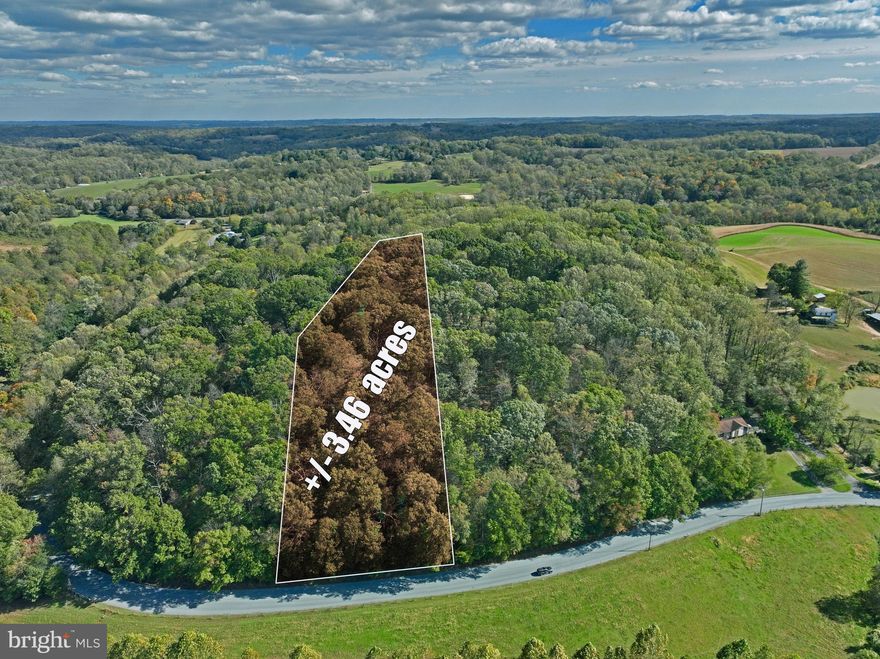 This 3.46-acre wooded parcel offers a rare opportunity to build your dream home with stunning views on top of this scenic hilltop parcel. Enjoy the perfect blend of rural tranquility and urban convenience in this growing community.  Property has satisfactory perc test from Harford County Health Department dated 3/4/25.  Electric utilities available at street.   The sloped terrain culminates in a prime bluff-top building site, offering panoramic views and privacy. Buyers should confirm current zoning regulations with local authorities to determine specific building possibilities.