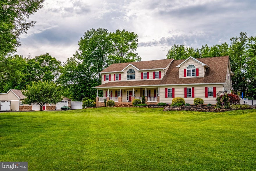 Exceptional craftsmanship in this custom-built estate offering approximately 3,200 square feet of living space. This stunning home offers resort-style outdoor living, 3-car attached garage, 4+ car detached converted pole barn, storage equipment shed as well as a standard storage shed. Set on beautifully manicured 4.79 acres and tucked away in the Heart of Waldorf.  This property offers unmatched privacy while remaining minutes from US Route 301 (Crain Highway) and MD Route 210 (Indian Head Highway). A stamped concrete walkway leads to a covered porch opening into a foyer with hardwood flooring and two-story grand staircase. The kitchen is designed for entertaining and functionality, featuring granite countertops, stainless steel appliances, and upgraded cabinetry.  A separate dining room provides for additional living space to entertain or relax. The living room features a wooden mantle from the early 1900's with a gas fireplace. Sliding doors seamlessly connect the indoor and outdoor living spaces. The primary suite offers walk-in closets and a primary bath with dual sink vanity and jetted soaking tub as well as a walk-in shower. Two additional bedrooms are located on the upper level with a shared full bathroom.  Home provides an approximately 900 square foot fully finished basement with a well-designed wet bar, living space, office, full bathroom and laundry room.  Home also offers a permitted apartment with kitchen, additional bedroom, full bath, and balcony overlooking the pool and backyard.  Step outside to your own private resort centered around a breathtaking heated pool and spa. Approximately 2,000 square feet of hardscape and decks surround the pool, providing ample space for lounging, additional seating or entertaining. The covered deck creates the ultimate outdoor entertaining area. Complete with a custom-stone outdoor kitchen and bar featuring granite countertops, built-in grill and cooktop, beverage refrigerators, outdoor TV mounting system, sound system and electric controlled blinds. Additional amenities include an outdoor pool equipment shed with full bathroom.  A detached 4+ car converted pole barn and climate-controlled office area as well as equipment storage shed offer offers additional storage or hobby space and large parking area. This remarkable estate combines luxury, modern convenience, privacy, and resort-style living into one truly unforgettable property in the Heart of Waldorf.