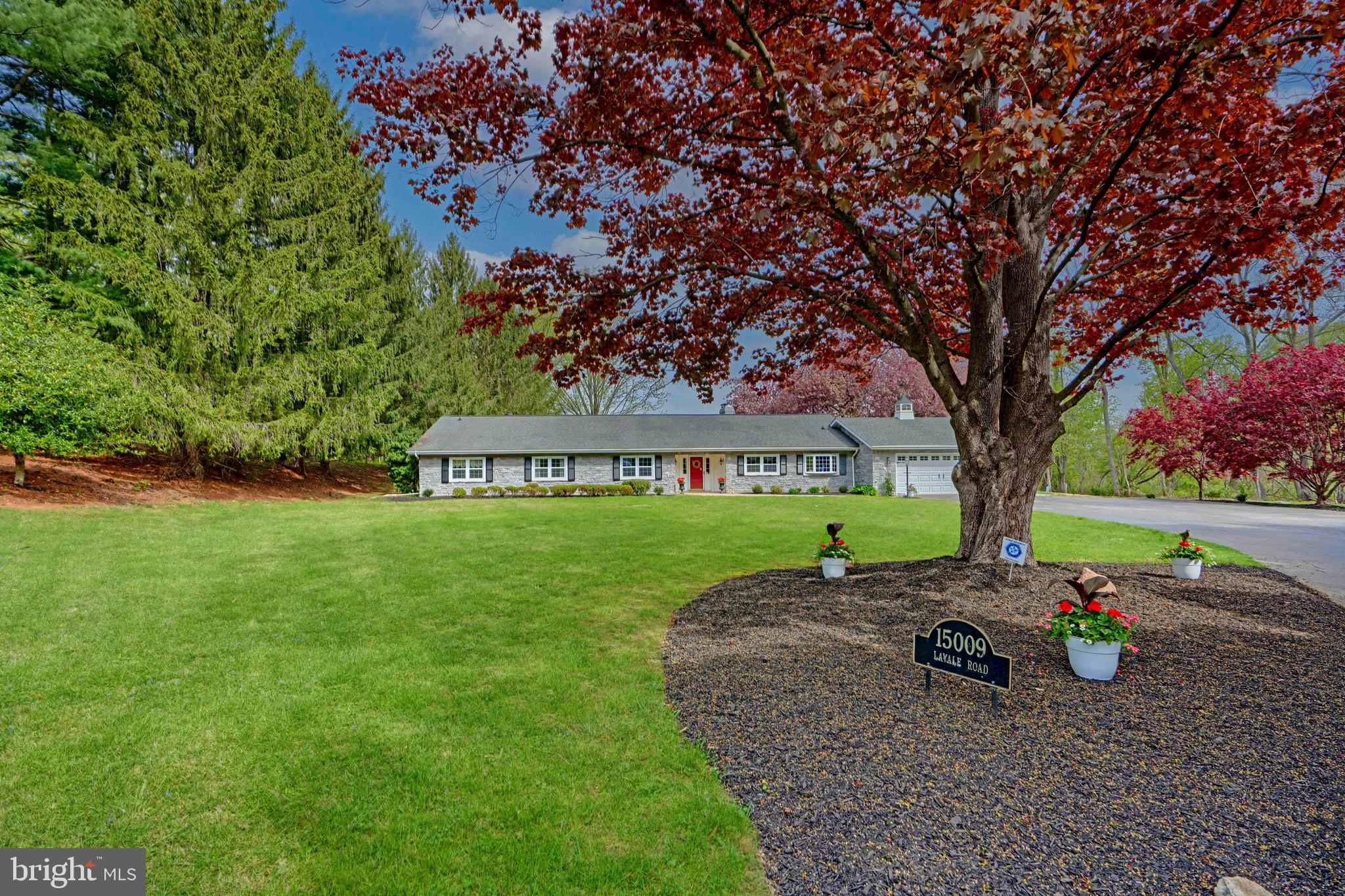 OPEN SUNDAY 12-2PM - Welcome to 15009 La Vale Rd—this exceptional custom Monkton rancher is tucked away but still close to Jacksonville’s shops and conveniences. This accessible one-level home offers privacy, views, timeless charm and the opportunity for generational living. Inside, find oversized rooms, detailed moldings, and two fireplaces. Enjoy indoor-outdoor living with Anderson sliders opening to a large screened porch. Five generous bedrooms, including a private primary suite, a large separate laundry/storage area, and an oversized 2-car garage with workshop. Set on a beautifully landscaped lot, perfect for a future pool. A rare gem offering true one-level living! (no basement) NEW Well just installed.