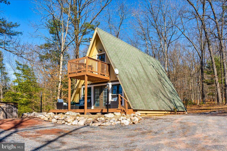 Tucked away in the peaceful woods, this charming cabin offers the perfect blend of privacy, comfort, and convenience. Situated on over 3 beautiful acres, this property is a true retreat where you can relax, unwind, and enjoy nature all around you. Inside, the home features 2 bedrooms, 1 full bath, and 1 half bath with a warm open-concept layout that makes the space feel inviting and functional. The kitchen is equipped with stainless steel appliances and flows seamlessly into the living area—perfect for everyday living or entertaining guests. Step outside and enjoy multiple spacious decks ideal for morning coffee, evening gatherings, or simply soaking in the quiet wooded surroundings. The property also includes several sheds for storage, plus a dedicated fire pit area that’s ready for cozy nights under the stars. Despite the peaceful setting, the location is incredibly convenient—just minutes from I-68, providing quick access for commuting, shopping, dining, and recreation. Whether you’re looking for a weekend getaway, full-time residence, or a private escape, this cabin offers the best of both worlds: seclusion, charm, and accessibility. Opportunities like this don’t come around often—schedule your showing and come experience this incredible find for yourself!