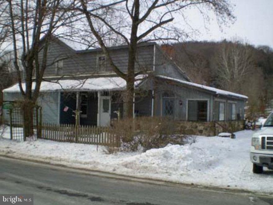 WOW! 1900 SF home, updated kitchen w/tile floor, LR w/original hardwood floor, mountain stone fireplace w/wooden mantel, FR w/skylights, tile floor, formal DR w/hearth, large detached 24x28' det. workshop w/furnace & electric, header installed to convert to garage! Close to State Game Lands! Needs some TLC to make it your very own OR make it your relaxing country getaway! PRICED TO MOVE!!