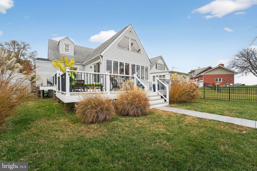 Experience true waterfront living in this charming coastal retreat featuring a main-level bedroom and full bathroom, perfect for comfort and convenience. The updated kitchen flows seamlessly into bright, open living spaces that capture an expansive, unobstructed view stretching all the way to the Eastern Shore. Upstairs, you’ll find two additional bedrooms, ideal for family or guests. Outside is a boater’s paradise—enjoy a 155 ft pier with an 18 ft bump-out, and a 10,000lb boat lift, water and electric already on the pier, and exceptionally deep water, accommodating virtually any size boat. The bulkhead is in fantastic shape, offering peace of mind for years to come. The property includes an oversized detached garage with abundant storage, plus an additional storage shed for all your equipment and outdoor toys. With a large yard perfect for entertaining, plenty of parking, and beautiful waterfront scenery everywhere you turn, this home is the perfect blend of comfort, convenience, and coastal living. Please schedule all showings online via Showing Time.