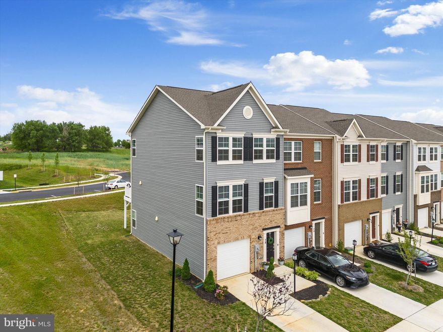 Welcome Home!  The NEW community POOL is within walking distance and is NOW OPEN!  This end-unit townhome has 3 finished levels and is super clean and MOVE-IN READY.   Built in 2022, this Lennar Savannah Model is like new, but with some rare upgrades you do not get on with all townhomes!  A half bath in the lower finished level and four added windows on the side of the home to bring in extra light.  The large open kitchen with center island and eat-in space opens to a large family room with great light.  This entire level has Luxury vinyl plank floors and opens to an 18x10 deck just off the kitchen. Perfect for entertaining, the large granite island has plenty of room for seating, multiple white cabinets underneath and electrical outlets on both sides.  **These are actual photos of the home.  Upstairs, the primary suite has an ensuite bath and walk-in closet.  The other two bedrooms on this level share a hall bath with a shower/tub combo.  The 1st floor is also finished with a walkout rec room, currently used as an office, and a half bath.  The entire house has been meticulously for and has an upgraded refrigerator and custom blinds already installed.  Seller pays HOA, common area maintenance, and trash service.  Conveniently located off of Route 340 in Charles Town with easy access to VA and MD commuter routes.