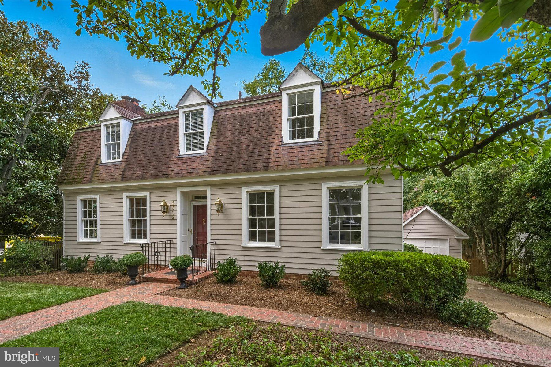 Welcome home to a quintessential Williamsburg Colonial, offering more than 3,000 square feet of living area across three generously proportioned levels in coveted Chevy Chase Village. With sunny, grandly scaled rooms, newly refinished wide-plank hardwood floors, oversized windows, French doors, bay windows, and cozy wood-burning fireplaces, this home radiates charm and character at every turn.
The main level features a welcoming foyer and entry hall that sets the stage for elegant entertaining. A formal dining room and living room with fireplace are complemented by a light-filled family room with floor-to-ceiling windows on two sides. At the heart of the home is the eat-in kitchen with its own brick fireplace, framed by custom built-ins and a cheerful bay window complete with a wide window seat. The kitchen showcases white cabinetry, subway tile backsplash, quartzite countertops, a six-burner Thermador gas range, KitchenAid appliances, and abundant storage — the perfect blend of style and function. A powder room and oversized coat closet complete this level.
Upstairs, you’ll find four well-appointed, light-filled bedrooms, including a serene primary suite with large windows, two closets, built-in shelving and desk, and a spa-like en suite bath with a walk-in shower, bench, double vanity, and stylish tile. Three additional bedrooms (all with hardwood floors) share a recently updated hall bath with bathtub.
The lower level offers a flexible recreation room, substantial storage, laundry, and another half bath, plus a separate rear entrance with easy access to the driveway. Outside, the front yard comes alive each spring with cherry and magnolia blossoms, while the fenced backyard features blooming hydrangeas and a graceful dogwood tree. A detached one-car garage adds both convenience and charm.
Recent Upgrades - new hot water heater, A/C, Bosch dishwasher, washing machine, and those gleaming refinished floors — mean this home is truly move-in ready.
Living in Chevy Chase Village comes with unmatched perks: 24-hour police service, lively community events, walkability to Broad Branch Market, two farmers’ markets, and local schools — plus twice-weekly trash collection right at your house (no dragging bins to the curb!).
4 bedrooms. 2 full baths. 2 half baths. Endless charm. Fantastic backyard. Fabulous location.
This is THE ONE you’ve been waiting for. Open Saturday & Sunday!