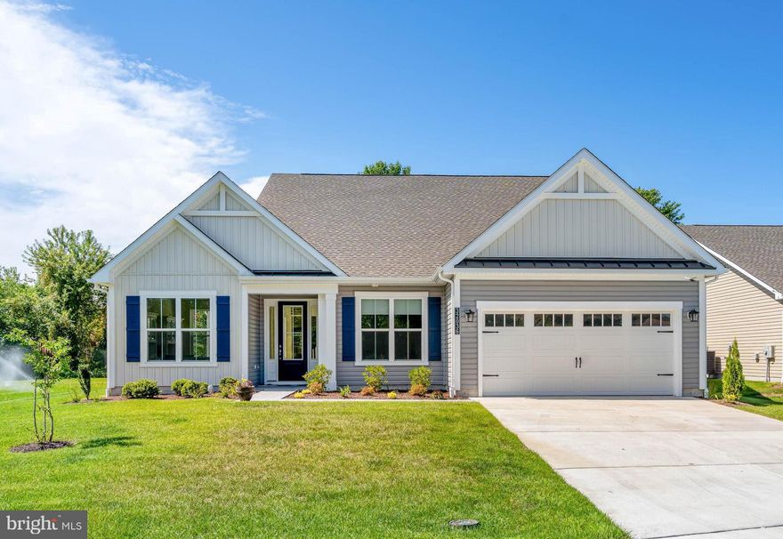 Set on one of Sycamore Chase’s most sought‑after private homesites with serene pond views, this beautifully crafted Dirickson floor plan offers 3,029 sq. ft. of coastal luxury living at its finest. Built in 2024 and gently lived in, the home has been elevated with thoughtful, high‑end enhancements including a custom‑tiled fireplace, upgraded primary closet organization, garage storage systems, paved walkways and porches, blackout bedroom blinds, designer lighting fixtures, and stunning quartz countertops.
Warm, sophisticated, and move‑in ready, this home also includes several rooms furnished with high‑end, coastal‑inspired pieces. The heart of the home flows effortlessly from the Gourmet chef’s kitchen and spacious dining nook into a sun‑drenched great room featuring vaulted ceilings and an elegant, ocean‑themed tiled gas fireplace.
The generously sized primary suite offers a tranquil retreat with a tray ceiling and a spa‑inspired bathroom complete with a soaking tub and custom medicine cabinets. Two additional guest bedrooms and a full bath are privately situated on their own wing of the main level, providing comfort and convenience. A stunning private office, enclosed by French doors and custom designed for both beauty and function, completes the first floor.
A beautiful open staircase leads to the upper level, where you’ll find an additional living room and a large bedroom with an attached full bath and a custom‑designed closet offering exceptional storage.
Experience luxury year‑round living or the ideal coastal retreat with convenient access to championship golf courses, the Bethany Beach Boardwalk, Fenwick Island State Park, and Bayside’s Freeman Arts Pavilion. Enjoy fantastic dining, shopping, and recreation all within minutes from home. With low HOA fees, peaceful community surroundings, and a property filled with premium upgrades, this is coastal living at its best!