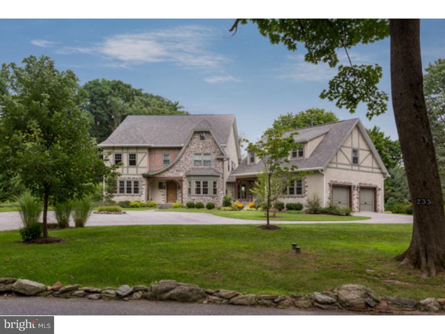 Enjoy a rare opportunity to own a magnificent, newly constructed home in Lower Merion without the hassles of building.  This masterfully crafted, 5 BR 4.2 BA center hall Tudor-symmetry colonial built in 2012 in the heart of Penn Valley has been meticulously designed by home enthusiasts to reflect the features desired by today's modern buyer seeking to combine smart design with character and tradition:  5 ft recessed panel wainscoting, 5" pre-finished HW floors, 9 ft.ceilings, gorgeous crown molding, Andersen windows, hardwired security system, generator, quartz countertops and custom closets, including elevator-capable closets ready for conversion. From the large center hall with powder room, enter the sun-drenched LR with transom windows and French doors that pour onto the side yard. Opposite LR is sizeable DR with beautiful bay window and recessed lighting. Continue to large office/den and the mud rm w/ cubbies & informal PR leading to oversized 2-car garage. Next pass massive pantry capable of storing every goody imaginable and enter chef's optimum kitchen. Create masterpiece meals with commercial-grade 48" Wolf gas range w/ griddle & grill, industrial blower, double ovens, Wolf warming drawer, DW, Subzero refrigerator, farm sink and built-in MW/convection oven. Flooded with eastern sun, this room will quickly become a favorite w/ its 10-ft island enhanced w/ quartz countertops, vegetable sink & plenty of seating, separate built-in desk and adjacent light & airy breakfast room.  Breakfast room exits to lovely bluestone covered patio w/ A-framed ceiling, which in turn leads to property's "stone house." Part of original grounds, this multi-purpose heated stone house w/ gorgeous loft ceiling adorned with original beams and ceiling fans could be separate office, studio or future cabana.  Also off kitchen is welcoming FR complete with gas FP w/ mantle and arabesque tile, coffered ceiling and French doors to additional bluestone patio. Upstairs, master suite includes large BR w/his/her closets, one w/pocket door to laundry room, & sun-filled BA w/soaker tub & shower, his/her quartz-topped vanity and separate commode room. 2nd level offers 3 add'l generous BRs, 1 en suite & 2 w/built-ins that share jack & jill BA. Complete over-garage apt offers every amenity including LR w/built-ins, kitchenette, W/D, cozy BR & BA. Circular driveway; perfectly level, professionally manicured 1.1 acre lot; award-winning Lower Merion schools.