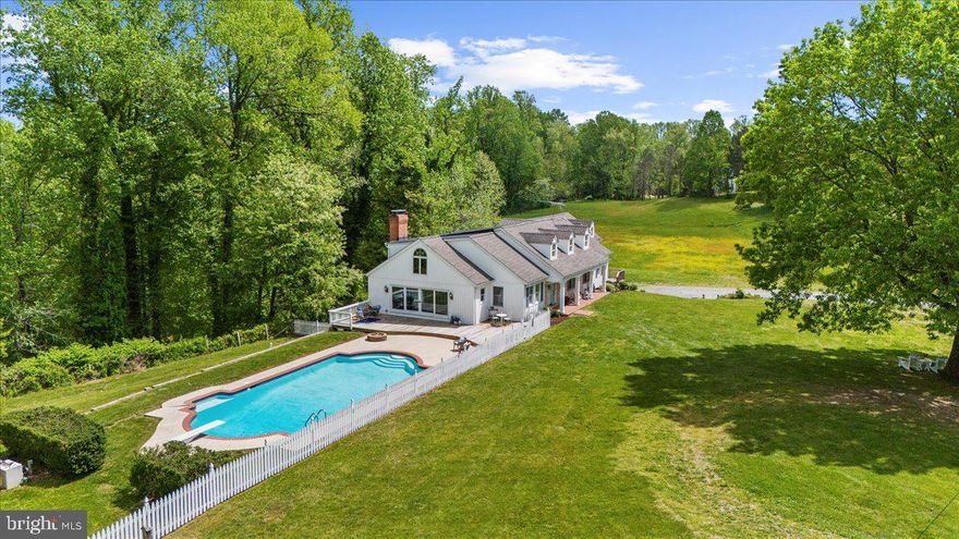 Whether you envision a hobby farm, multi-generational retreat, or a private escape to roam freely, this property blends lifestyle, luxury, and potential.  Discover a rare 40+ acre retreat just minutes from downtown Annapolis, offering unmatched privacy, charm, and versatility. Tucked away on a quiet, no-through road, this property is a true sanctuary with rolling pastures, mature trees, and multiple outbuildings—including a barn and former horse corral.
This modern farmhouse has been thoughtfully upgraded with approximately $200,000  in renovations, including improvements to the roof, barn, electrical system, plumbing, fresh paint, new flooring, and updated bathrooms, making it move-in ready while preserving its storybook charm. Inside, six bedrooms and six bathrooms provide ample space. The main level features a welcoming kitchen with new quartz countertops flowing into a cozy family room with exposed beams and a fireplace. Entertain in the spacious dining room, or step into the sun-drenched office/parlor overlooking magnolia trees. The main floor also includes three bedrooms, highlighted by a luxurious primary suite with ensuite bath, private entrance, and panoramic pasture views. Upstairs, three additional bedrooms include one with a private bath and two connected by a charming secret passageway, with a nearby full renovated bath. 

The lower level offers a large recreation/tack room, workshop, additional half bathroom, and direct access to the three-car garage. Outside, tiered gardens, trails, and multiple activity areas—including a pool, golf practice area, and a secluded campsite with a fire pit—offer endless options for recreation and relaxation. The property invites outdoor adventure, with ATV trails, scenic hiking paths, and natural areas ideal for foraging and plant identification.

Conveniently located near golf courses, dining, shopping, and boating, this is more than a home—it’s a rare opportunity to enjoy a turnkey property with room to grow. Sale includes the 5-acre parcel known as 1118 Gumbottom Rd.
