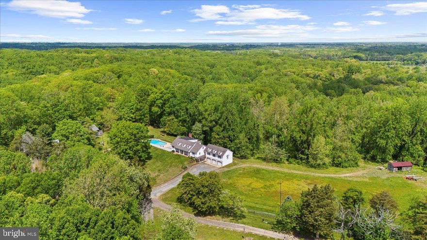 Rare offering: 40 expansive acres accompanied by a separate 5-acre  lot with passing 1997 perc test on file (county approval required;buyers to verify).Whether you envision a hobby farm, multi-generational retreat, or a private escape to roam freely, this property blends lifestyle, luxury, and potential.  Discover a rare 40+ acre retreat just minutes from downtown Annapolis, offering unmatched privacy, charm, and versatility. Tucked away on a quiet, no-through road, this property is a true sanctuary with rolling pastures, ATV trails, mature trees, and multiple outbuildings—including a barn and former horse corral.
This modern farmhouse has been thoughtfully upgraded renovations, including improvements to the roof, barn, electrical system, plumbing, fresh paint, new flooring, and updated bathrooms, making it move-in ready while preserving its storybook charm. Inside, six bedrooms and six bathrooms provide ample space. The main level features a welcoming kitchen with new quartz countertops flowing into a cozy family room with exposed beams and a fireplace. Entertain in the spacious dining room, or step into the sun-drenched office/parlor overlooking magnolia trees. The main floor also includes three bedrooms, highlighted by a luxurious primary suite with ensuite bath, private entrance, and panoramic pasture views. Upstairs, three additional bedrooms include one with a private bath and two connected by a charming secret passageway, with a nearby full renovated bath. 

The lower level offers a large recreation/tack room, workshop, additional half bathroom, and direct access to the three-car garage. Outside, tiered gardens, trails, and multiple activity areas—including a pool, golf practice area, and a secluded campsite with a fire pit—offer endless options for recreation and relaxation. The property invites outdoor adventure, with ATV trails, scenic hiking paths, and natural areas ideal for foraging and plant identification.

Conveniently located near golf courses, dining, shopping, and boating, this is more than a home—it’s a rare opportunity to enjoy a turnkey property with room to grow. Sale includes the 5-acre parcel known as 1118 Gumbottom Rd.(a previous perc was done in 1997).*Per the county, buyers must verify independently. Agents please see remarks.