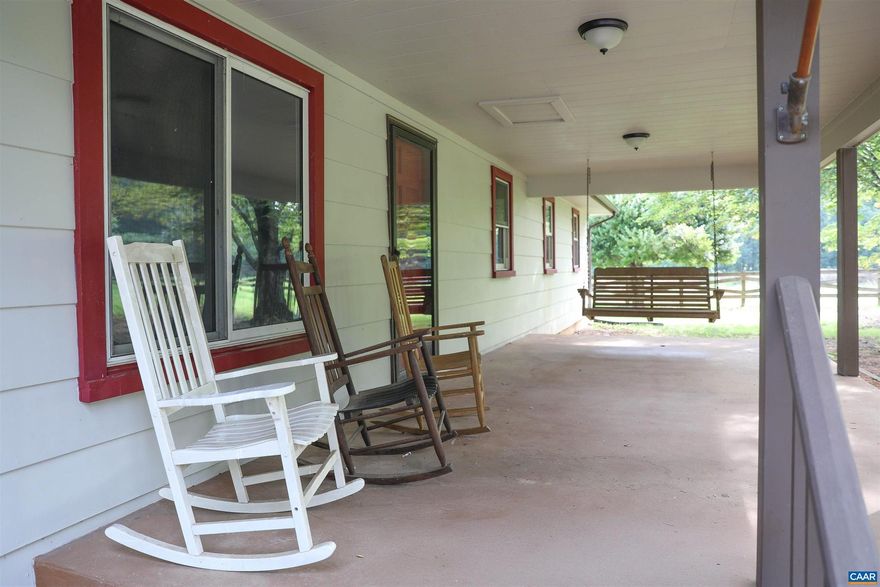 Back on market no fault of sellers. Priced to sell! Don't miss this amazing opportunity! Charming Farmhouse with Mountain Views near Chris Greene Lake Park! Over 3+ acres in Albemarle County, this beautiful ranch offers the perfect blend of rustic charm and modern convenience. Just a short drive to UVA and the area's best restaurants and attractions. Inside, you?ll find 4 spacious bedrooms with fresh paint, new carpet and an open concept living dining and kitchen space with a cozy wood-burning stove. Outside you'll love the stunning mountain views, a classic front porch swing, back deck, and a large barn with partially fenced yard. The covered breezeway leads to a two-car garage, with extra storage and workspace. With a recently serviced HVAC and some interior updates, this home is eagerly waiting for its new owners to come and make it their own!,Wood Cabinets,Fireplace in Living Room