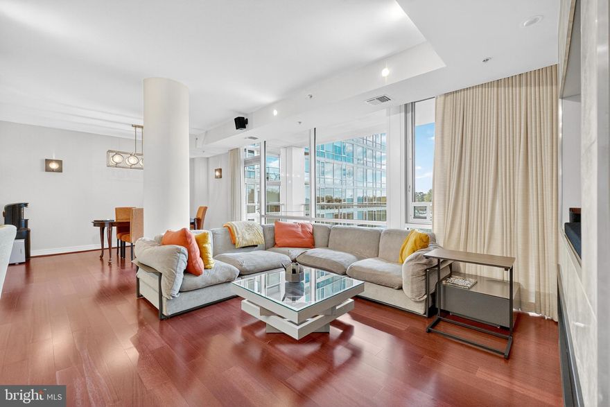 Welcome to The Adagio—luxury condominium living in the heart of Chevy Chase / Bethesda. Residence #4006 offers 3 bedrooms, 3 full baths, and a large private balcony with tranquil courtyard and tree-top views. Floor-to-ceiling windows flood the home with natural light, complemented by open-concept living and dining spaces anchored by a custom electric fireplace and built-in media wall, as well as a thoughtfully designed custom bar installation that enhances both functionality and entertaining. The chef’s kitchen is appointed with premium appliances including Sub-Zero refrigeration, Wolf double ovens, Bosch and Miele, further elevated by a custom backsplash, upgraded lighting, and dimmers throughout. The home has been extensively improved with designer finishes, including full interior paint across all walls, doors, and moulding, along with carefully selected lighting fixtures that create a cohesive and elevated aesthetic. All three bedrooms are thoughtfully designed with professionally installed custom closets, built-in desks, shelving, and wall sconces for layered lighting—offering exceptional flexibility for guest use, work-from-home needs, or both. The primary suite features a spacious custom walk-in closet and a spa-like bath with double vanity and soaking tub. Additional highlights include remote-controlled Hunter Douglas custom blinds and curtains throughout, custom window treatments, a separate laundry room with high-end washer/dryer and added custom shelving, and multiple appliance upgrades including a new dishwasher. The home is also equipped with two newer Carrier HVAC systems paired with Nest thermostats for modern efficiency and comfort. Additional design enhancements such as wallpaper accents and upgraded fixtures further contribute to the home’s turnkey condition. Two garage parking spaces and a private storage unit convey. The Adagio is a full-service, 24-hour concierge building featuring a fitness center, library, social lounge, guest suite, landscaped courtyard, guest parking, and recently renovated common areas. Unbeatable location moments from shopping, dining, parks, and Metro access. A rare opportunity to own a fully upgraded, turnkey luxury residence in one of Bethesda’s premier buildings. HOA dues cover gas and water. Furniture can be included in the sale