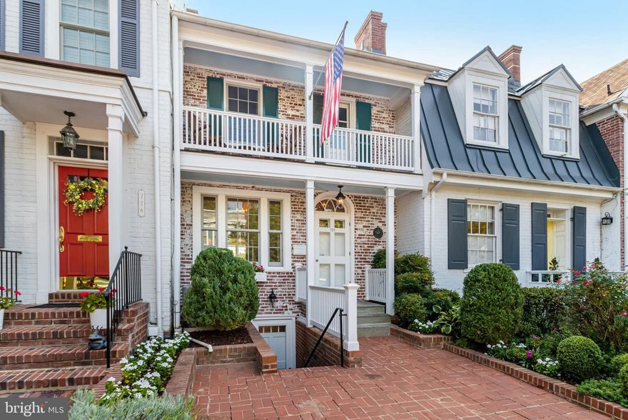 Located on one of Old Town’s most desired streets, this picturesque home is offered in pristine, move-in condition. From the charming, covered front porch enter into the beautiful and spacious living room with hardwood floors, a gas or woodburning fireplace, and a lovely window seat flanked by built-in bookcases. Enter seamlessly into the formal dining room, where you will discover a tucked-in storage cabinet with a glass front, one of the many unique features of the home. The expanded gourmet kitchen offers a plethora of cabinet storage, granite counters, stainless steel appliances, and peninsula seating. The adjoining family room is a cozy space with a gas fireplace, additional built-ins, and dynamite views out the back of the home. Conveniently located off the kitchen is a deck with stair access to the garden. The primary bedroom is an oasis with a spa-like bath, gas fireplace, walk-in closet, and private balcony overlooking the rooftops. The highlight of the second bedroom is the bed nook with recessed reading lights and direct access to the covered porch, with classic blue painted ceiling, overlooking S. Lee Street. The office on this level is outfitted with floor-to-ceiling built-ins including file storage, bookshelves and two workstations. The skylight floods the room with natural light making it a cheerful workspace. The hall bath has been fully remodeled and includes a custom glass shower door. The lower level includes a family room or third bedroom, sitting room, kitchenette, laundry, and a third full bath. With a front exterior entrance and garden access there are many possibilities for this versatile space. The private back patio and garden showcase lush plantings and a covered seating area. Leave your car in the dedicated driveway parking, a rare find in this quaint town, and walk to the shops and restaurants on King Street or wander to the many parks and trails along the waterfront. This prime location affords easy access to major commuter routes, Metro, Reagan National Airport, Amazon HQ, and Washington, DC.