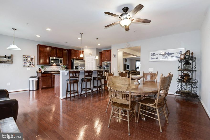 Nearly 2,700 sqft UPPER LEVEL two-story condo townhouse with 9 ft ceilings, open floor plan. Gleaming hardwood floors beautify main level as well as Master Bed. Beautiful Gourmet kitchen offers granite countertops, nice backsplash, upgraded stainless steel appliances, cherry cabinets with crown molding, center island with  breakfast bar. Spacious walk in pantry, a cooktop and double wall ovens! Spend quality time at Deck. Living Dining Area altogether. Spacious master bedroom with HIS and HER walk in closets. Master bath features dual vanities, luxury shower with frameless door, ceramic tile , tiled floor and dual shower heads. Front loading washer and dryer are at bedroom level. Spacious other two bedrooms share upgraded bathroom with a dual vanity. 1 Car Garage is Cherry on Top.  WATER INCLUDED IN RENT. Walk to future Silver Line metro & Starbucks! Easy access to Toll Road, Brambleton. Available NOW.