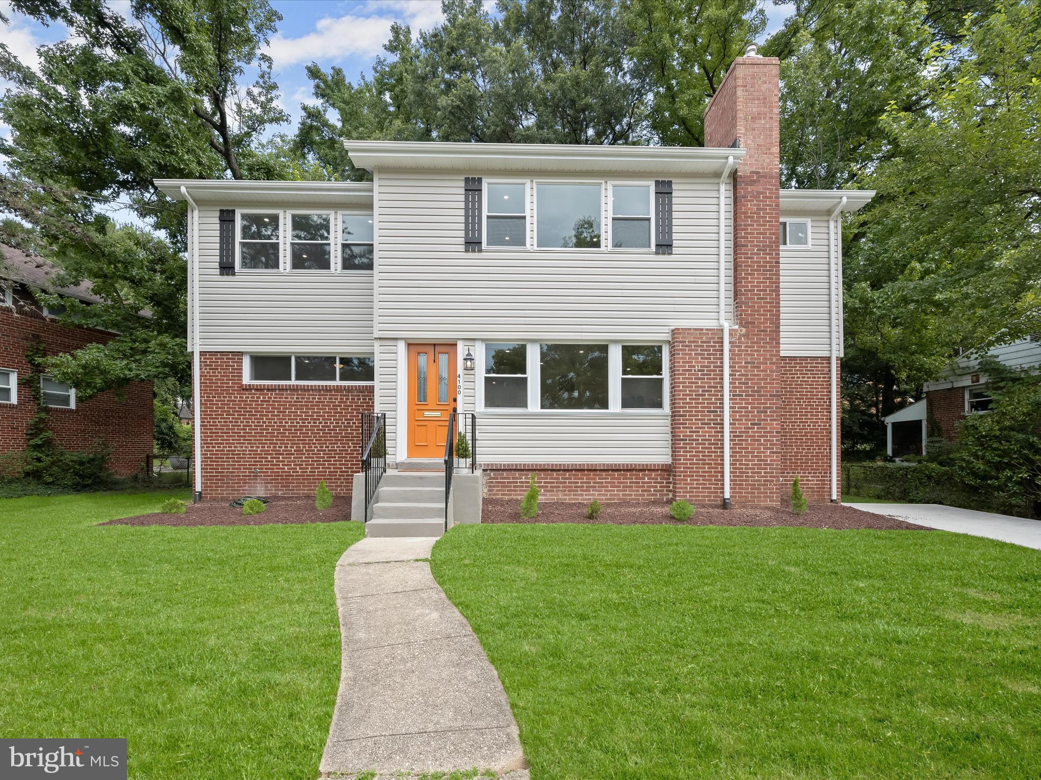 Completely reimagined in 2024, this stunning residence in the heart of historic University Park offers nearly 4,000 square feet of beautifully finished living space, seamlessly blending modern design with timeless charm. With 5 bedrooms, 4.5 baths, and dual primary suites, one on the main level and another upstairs, this home is thoughtfully designed for comfort, flexibility, and multi-generational living.
Striking curb appeal welcomes you, hinting at the impeccable design found within. Step through the front door into an airy, open-concept main level, where warm hardwood floors and recessed lighting flow throughout expansive living, dining, and kitchen spaces. A picture window in the living room fills the space with natural light and beautifully illuminates the wood-burning fireplace with its white brick surround. The adjacent dining room flows effortlessly into the kitchen, where no detail was spared, from soft-close white 42-inch cabinetry and quartz countertops to a tile backsplash and sleek stainless steel appliances, including a gas range. Brass and black hardware add a sophisticated edge throughout the home, complementing the curated, design-inspired finishes. The main level also includes a luxurious primary suite featuring a spacious walk-in closet and a spa-like en suite bath with a double vanity and a glass-enclosed wet room that combines a rainfall shower and soaking tub for ultimate relaxation. Upstairs, four sizable bedrooms include a second primary suite complete with three closets and a stylish attached bath with a dual-sink vanity. A full hall bath and a cozy loft area, perfect for a desk or reading nook, round out the upper level. Just a few steps down from the kitchen, a large family room addition offers a vaulted ceiling, electric fireplace, and access to the side yard, making it an ideal space to unwind or entertain. The finished lower level expands the living space with a sprawling recreation room, an additional full bath, a large laundry room, and a walk-in storage room, providing abundant functionality for modern lifestyles. Out back, the fully fenced yard is both private and practical, complete with a storage shed and plenty of room to garden, play, or host gatherings. A generous driveway allows parking for multiple vehicles. Every major system has been updated for peace of mind: roof, water heater, appliances, windows, and dual-zone HVAC were all replaced in 2024. Enjoy the best of small-town charm and city convenience just steps from the neighborhood park, playground, EV charging station, and all that University Park has to offer. With easy access to two Metro stations, the MARC train, University of Maryland, Trader Joe’s, Riverdale Town Center, and the upcoming Purple Line, this rare find combines history, luxury, and location into one truly exceptional home. Please note: photos depicting furniture have utilized virtual staging.