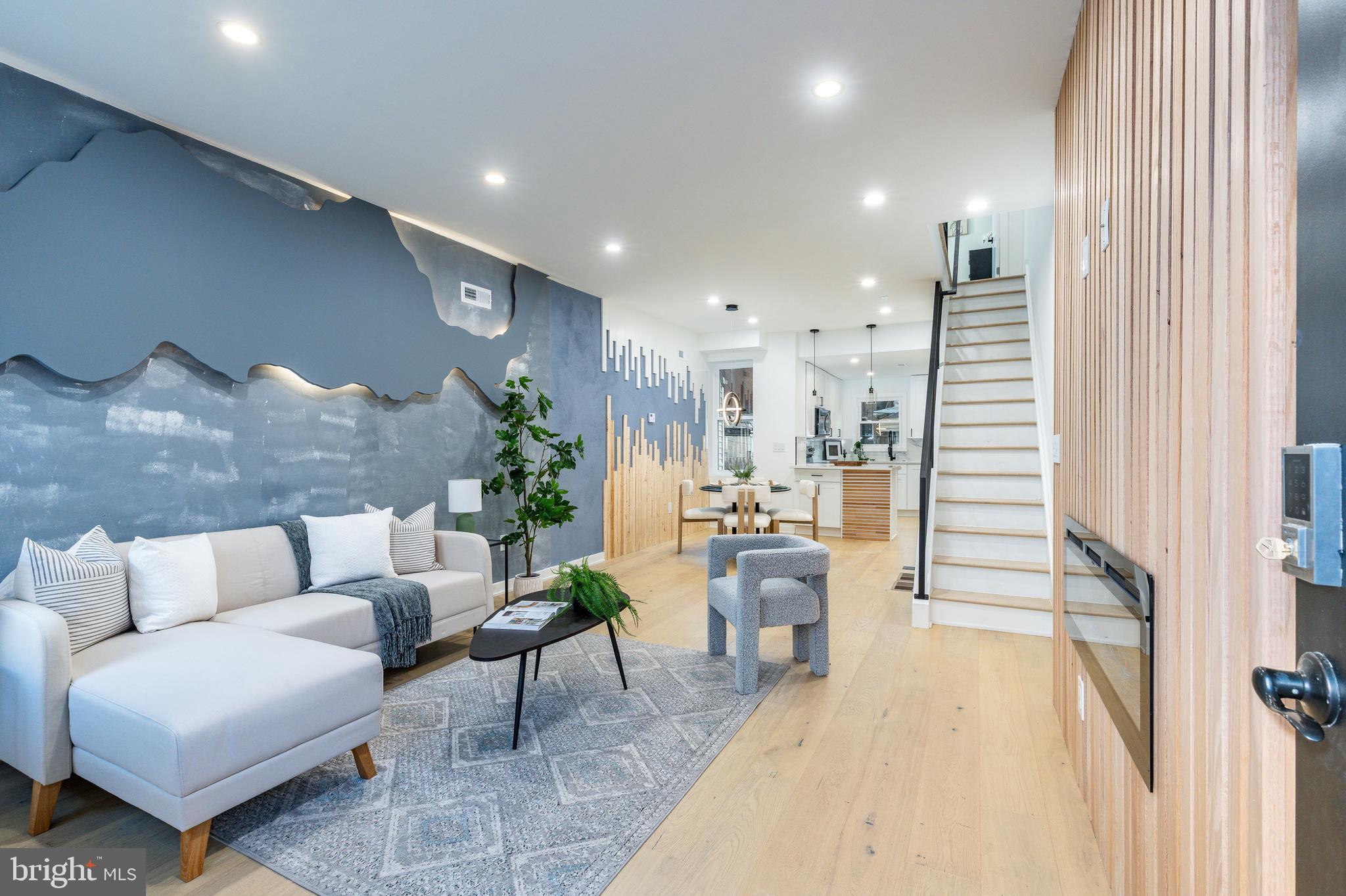 Welcome to your dream home—where modern design meets urban convenience! This stunning 2-bed, 2-bath gem isn’t just a house… it’s a whole vibe. Step inside and BOOM—you’re greeted by a bold designer statement wall, sleek recessed lighting, and an electric fireplace that sets the perfect mood. The open-concept living space flows into a jaw-dropping kitchen with quartz countertops, a waterfall-edge, and white shaker cabinetry with black hardware. White oak hardwood flooring add elegance, while the fully finished basement offers extra living space, laundry, storage, and gorgeous custom full bath with shower. Upstairs you will find 2 bedrooms with the primary featuring a custom black accent wall with sconce lighting and restored wood desk to work from home in style! The full bathroom on this floor will impress with trendy finishes. Plus, this home qualifies for the Bank of America grant—making luxury more affordable.
Location? Absolutely unbeatable. Just minutes from Frankford Ave’s buzzing restaurants, Aramingo Ave’s shopping (ShopRite, Ross, and more), and easy I-95 access. Walk to parks, gyms, and public transit, or explore Port Richmond’s eclectic dining scene. With a fireplace for cozy nights and chic custom details at every turn, this move-in-ready haven is waiting for you. Your vibe is here—claim it!
