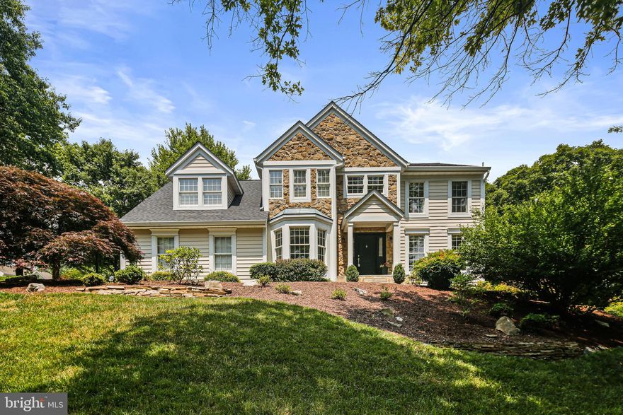 Welcome to 9701 Robert Jay Way!  This gorgeous home features a charming flagstone front sidewalk and porch, complemented by columns and a stunning stone front. As you step inside, you'll be greeted by a two-story foyer with beautiful earth-tone hardwoods, chair rail, and window pane trim, creating a warm and inviting vibe. The main level includes a variety of living spaces designed for both relaxation and productivity. Imagine working from home in the main level office, complete with French doors and a bay window that fills the room with natural light. The living room has windows on two sides, providing calming views of nature. Adjacent to the living room, the dining room is enhanced by chair rail, window pane trim, and an exquisite chandelier. The heart of the home lies in the family room, where you can unwind and gather with family and friends. The vaulted ceiling and the fireplace create a cozy atmosphere. Recessed lighting along the wall illuminates the space perfectly. Connected to the family room is the gourmet kitchen, featuring white cabinets, a wall oven and microwave, granite countertops, and stainless steel appliances. With recessed and undercabinet lighting, meal preparation becomes a breeze. The kitchen also offers a convenient coffee nook, perfect for kicking off your day! Need a place to unwind? Retreat to the upper-level owner's suite with a vaulted ceiling and space for an office or meditation/yoga area. The ensuite bathroom has a soaking tub and double sinks with chrome faucets. Three additional bedrooms and a full bath are just down the hall. The finished basement offers a flexible space for entertaining and is a great space for movie nights or a pool table. There is a full bath as well as two additional rooms in the lower level that would be great for overnight guests, a gym, a gaming room, or a craft room. You’ll love the outdoor spaces featuring a paver patio, deck, and beautifully mulched beds filled with mature plants and trees. There is so much to love about this house. Welcome home!