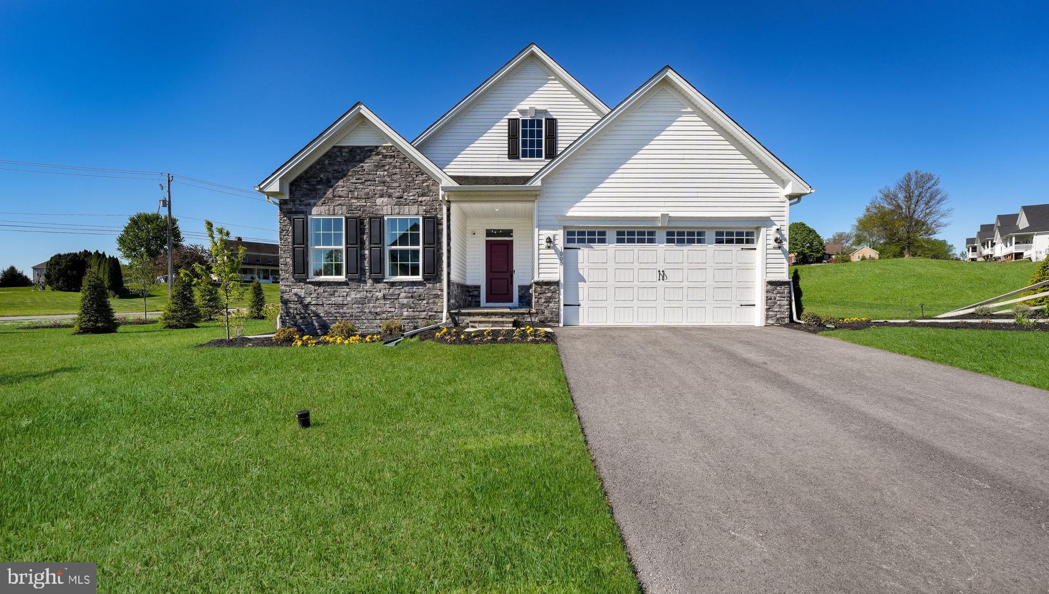 Welcome to 1000 Gilray Drive – the former model home in the vibrant 55+ community of Brandywine Walk! This thoughtfully designed 2-bedroom, 3-bathroom home offers the ease of main-level living, a fully finished basement with an additional bedroom and full bathroom, and a 2-car garage—all ready for immediate enjoyment. Situated on one of the most desirable homesites in the community, you're greeted by a charming, covered bluestone porch. Step inside to find luxury vinyl plank flooring, soaring 9-foot ceilings, and an open concept layout perfect for modern living. Just off the foyer, Bedroom #1 features recessed lighting, a walk-in closet, and an adjacent full bath with dual vanities and ceramic tile. A custom built-in drop zone connects the garage entry and mudroom, ideal for daily organization. Nearby, French doors lead into a spacious home office or flex room, complete with double windows overlooking peaceful natural views. The heart of the home is the open-concept kitchen, dining, and living area. The kitchen is a chef’s dream with quartz countertops, tile backsplash, stainless steel appliances, an oversized center island, abundant cabinetry, and a walk-in pantry. The adjoining dining area flows effortlessly into the bright and airy family room with recessed lighting and sliding glass doors to the covered rear porch—perfect for morning coffee or evening entertaining. The spacious primary suite features a tray ceiling, recessed lighting, and a generous walk-in closet. The en-suite bath includes dual vanities, a dedicated make-up area, a linen closet, and a ceramic tile shower. Convenience continues with a laundry room just steps from the primary suite. Downstairs, the finished lower level expands your living space with a large recreation area ideal for hosting guests, watching the big game, or creating a second family room. Bedroom #3 and full bathroom with upscale finishes offer excellent guest accommodation, while the unfinished section provides ample storage or workshop potential. Built in 2024 and still maintained by the builder, this home includes serviced mechanicals and a sump pump with water jet backup for added peace of mind. Brandywine Walk offers an unbeatable location close to Routes 322 and 30, the Thorndale Train Station, and everything Chester County has to offer. Schedule your showing today and discover why this active adult community is one of the area’s most exciting new places to call home!