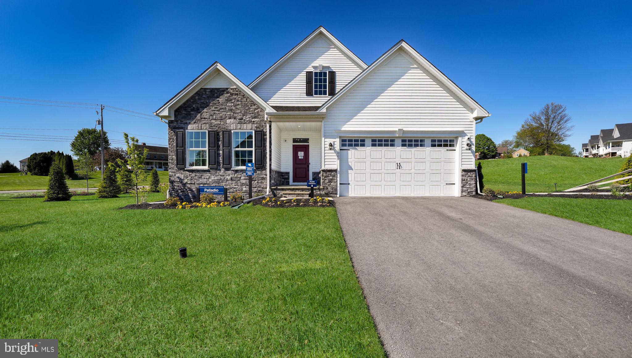 Welcome to 1000 Gilray Drive – the former model home in the vibrant 55+ community of Brandywine Walk! This thoughtfully designed 2-bedroom, 3-bathroom home offers the ease of main-level living, a fully finished basement with an additional bedroom and full bathroom, and a 2-car garage—all ready for immediate enjoyment. Situated on one of the most desirable homesites in the community, you're greeted by a charming, covered bluestone porch. Step inside to find luxury vinyl plank flooring, soaring 9-foot ceilings, and an open concept layout perfect for modern living. Just off the foyer, Bedroom #1 features recessed lighting, a walk-in closet, and an adjacent full bath with dual vanities and ceramic tile. A custom built-in drop zone connects the garage entry and mudroom, ideal for daily organization. Nearby, French doors lead into a spacious home office or flex room, complete with double windows overlooking peaceful natural views. The heart of the home is the open-concept kitchen, dining, and living area. The kitchen is a chef’s dream with quartz countertops, tile backsplash, stainless steel appliances, an oversized center island, abundant cabinetry, and a walk-in pantry. The adjoining dining area flows effortlessly into the bright and airy family room with recessed lighting and sliding glass doors to the covered rear porch—perfect for morning coffee or evening entertaining. The spacious primary suite features a tray ceiling, recessed lighting, and a generous walk-in closet. The en-suite bath includes dual vanities, a dedicated make-up area, a linen closet, and a ceramic tile shower. Convenience continues with a laundry room just steps from the primary suite. Downstairs, the finished lower level expands your living space with a large recreation area ideal for hosting guests, watching the big game, or creating a second family room. Bedroom #3 and full bathroom with upscale finishes offer excellent guest accommodation, while the unfinished section provides ample storage or workshop potential. Built in 2024 and still maintained by the builder, this home includes serviced mechanicals and a sump pump with water jet backup for added peace of mind. Brandywine Walk offers an unbeatable location close to Routes 322 and 30, the Thorndale Train Station, and everything Chester County has to offer. Schedule your showing today and discover why this active adult community is one of the area’s most exciting new places to call home!