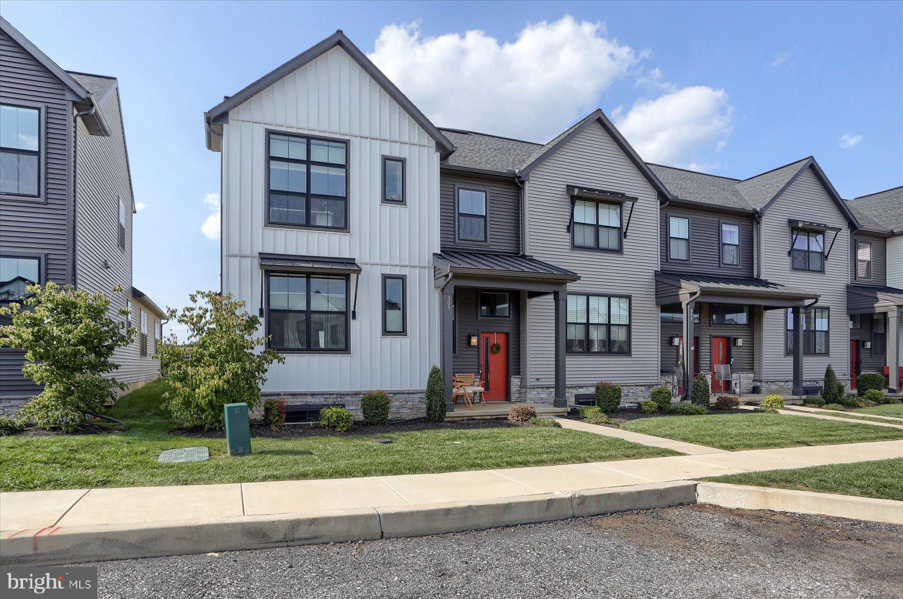 Welcome to this well-loved 2-story end-unit townhome featuring a quiet first-floor owner’s suite, vaulted ceilings in the living and dining rooms, and upgraded Sherwin Williams Emerald paint throughout. A rear load 2-car garage opens into a mudroom equipped with built-in lockers and access to the laundry and powder rooms. The living room, accented by an electric fireplace, flows into the kitchen featuring stainless steel appliances, quartz countertops, and shaker-style cabinets. Off the dining room, sliding glass doors lead to the fenced-in rear patio. The owner’s suite features a walk-in closet with IKEA PAX closet system, and a private bathroom with double-vanity. On the 2nd floor is a loft space, two additional bedrooms and a full bathroom.
Enjoy access to fantastic amenities like a playground, clubhouse with gym, scenic walking trails, and some of the best local spots including Wolf Brewing, Down to Earth Café, Luna Italian, and Taipei Chinese Kitchen. Don't miss your chance to see this amazing home in the Mechanicsburg Area School District!!